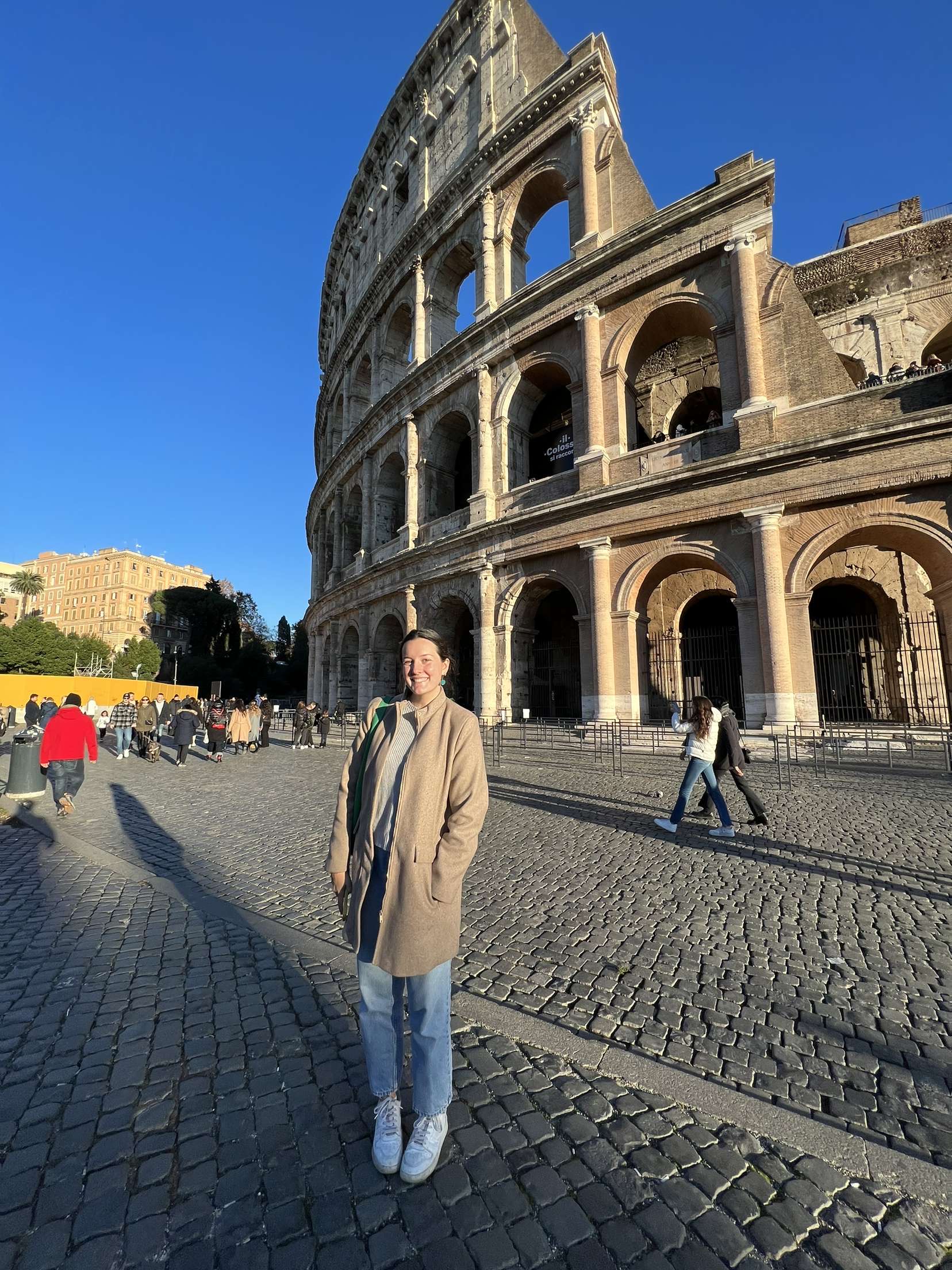 Girl standing in front of the Coliseum
