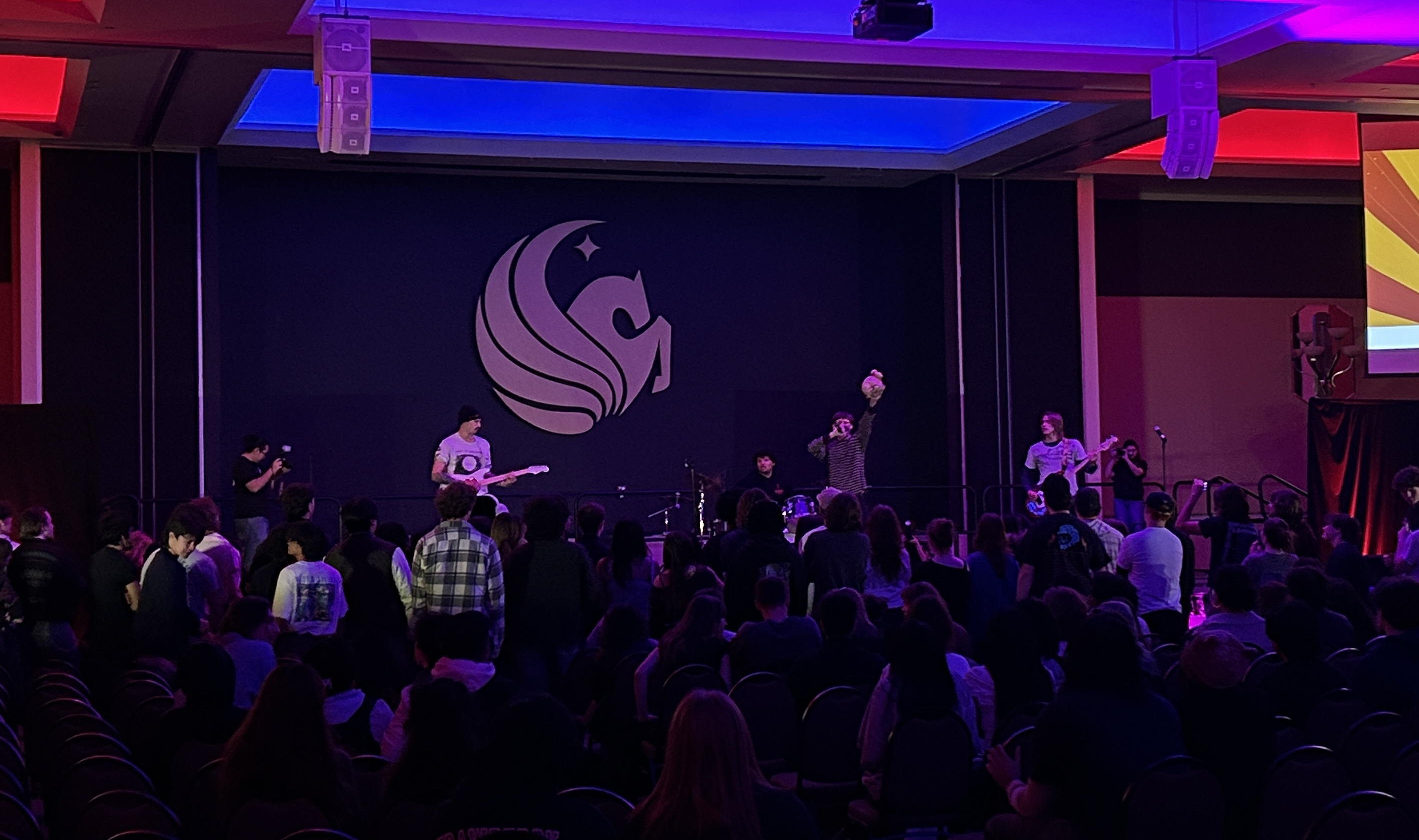 Shepherd performs with their signature prop sheep, held up by lead singer Aiden Shepherd