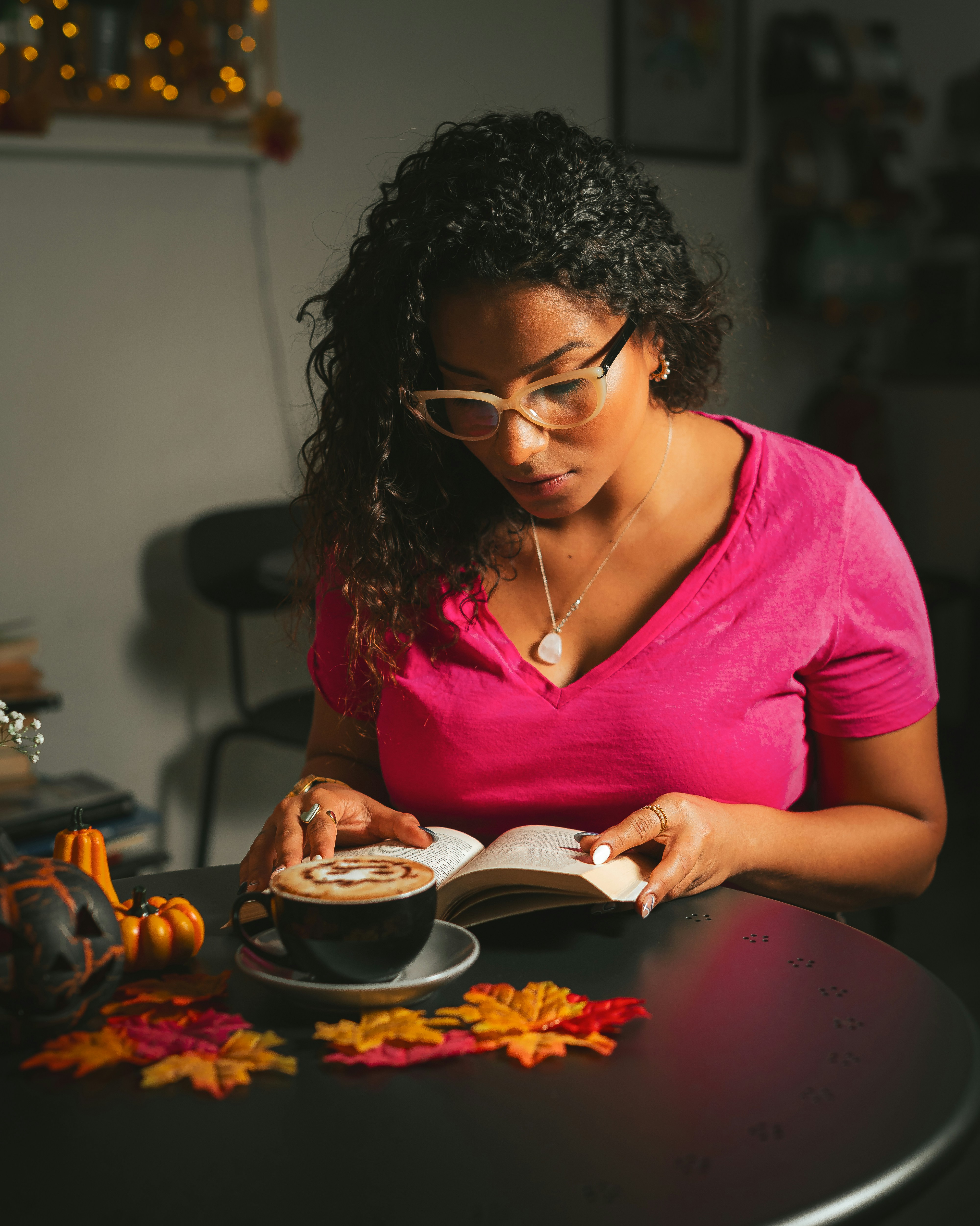 Woman reading at table with coffee