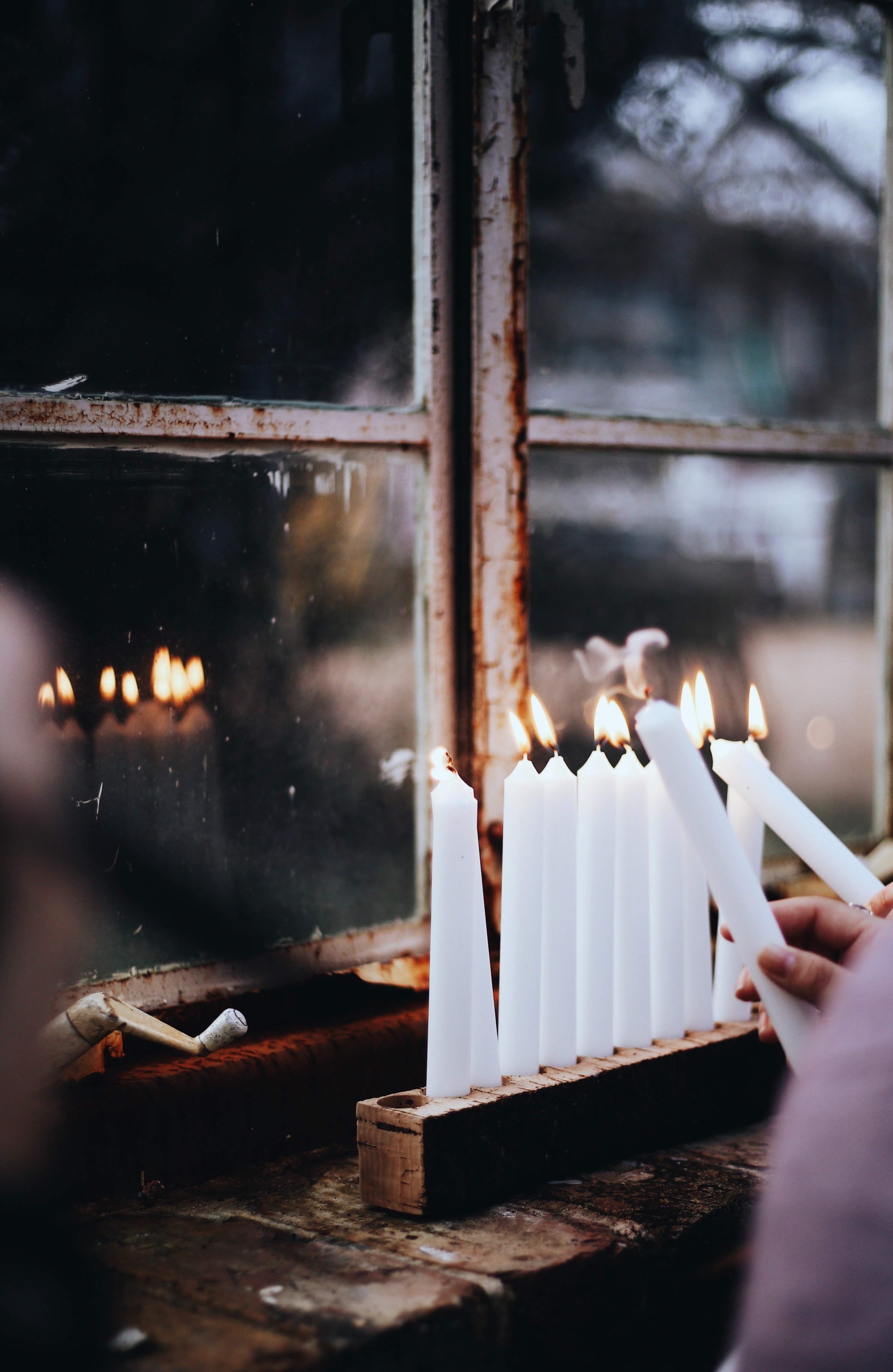 Menorah being lit by Enrique Macias on Unsplash?width=698&height=466&fit=crop&auto=webp&dpr=4