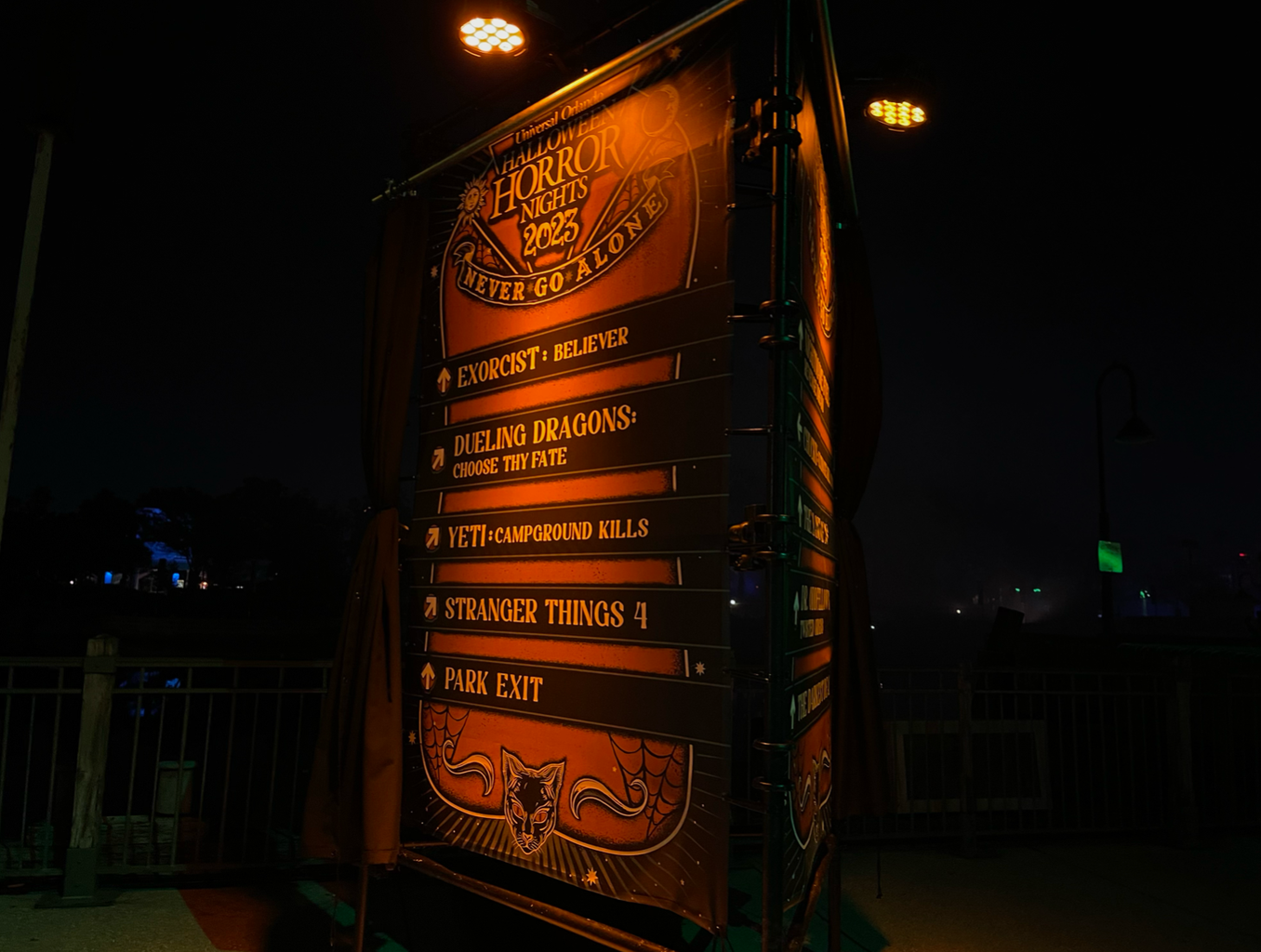 Halloween Horror Nights sign with houses listed