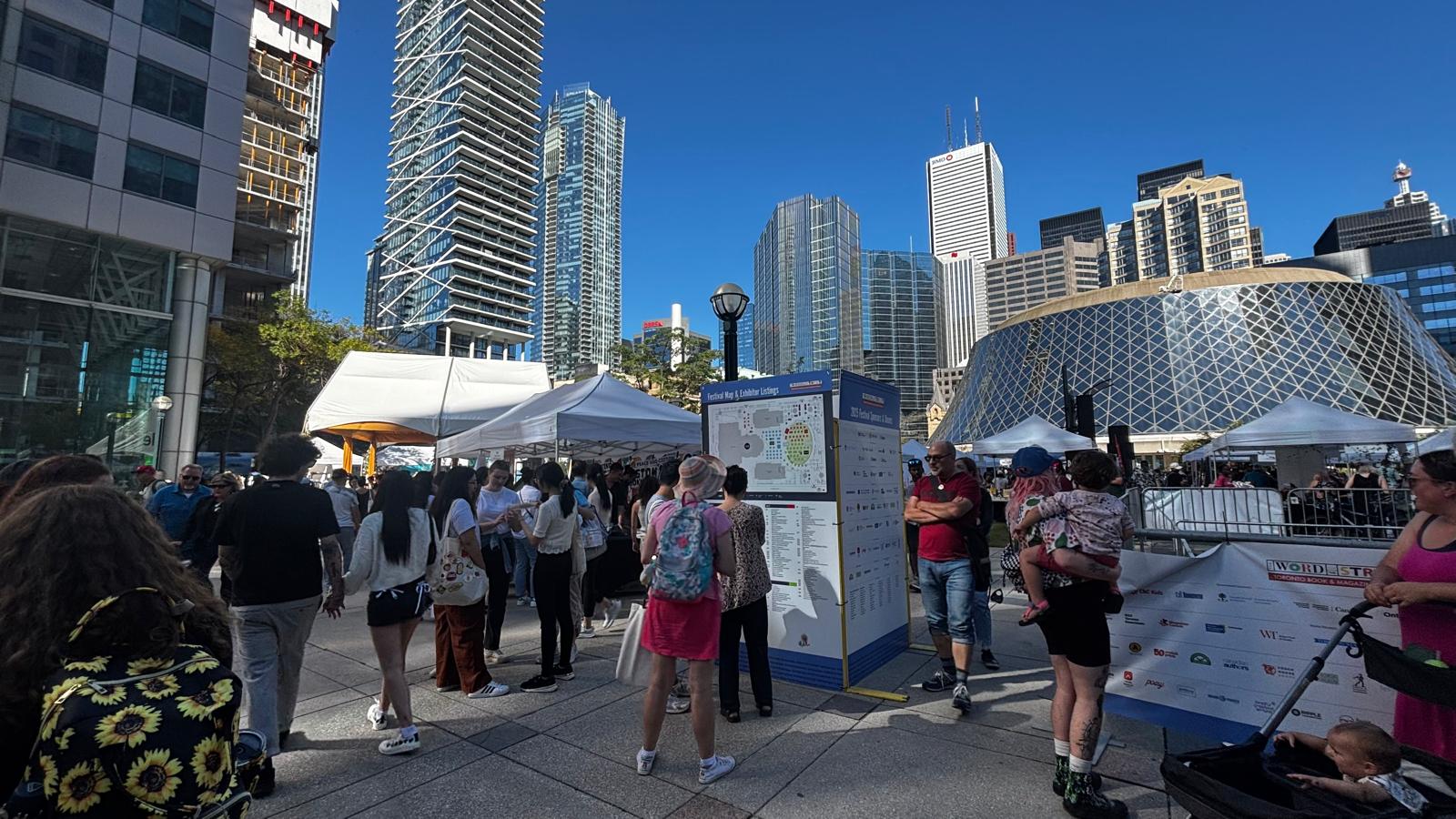 A image of people attending an outdoor event in downtown Toronto near Roy Thomson Hall.