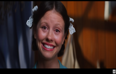 The actress Mia Goth performing as Pearl in the movie trailer.