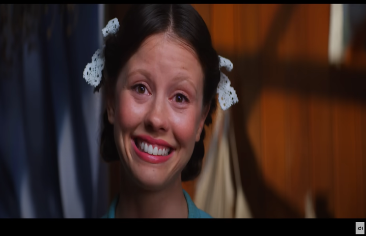 The actress Mia Goth performing as Pearl in the movie trailer.