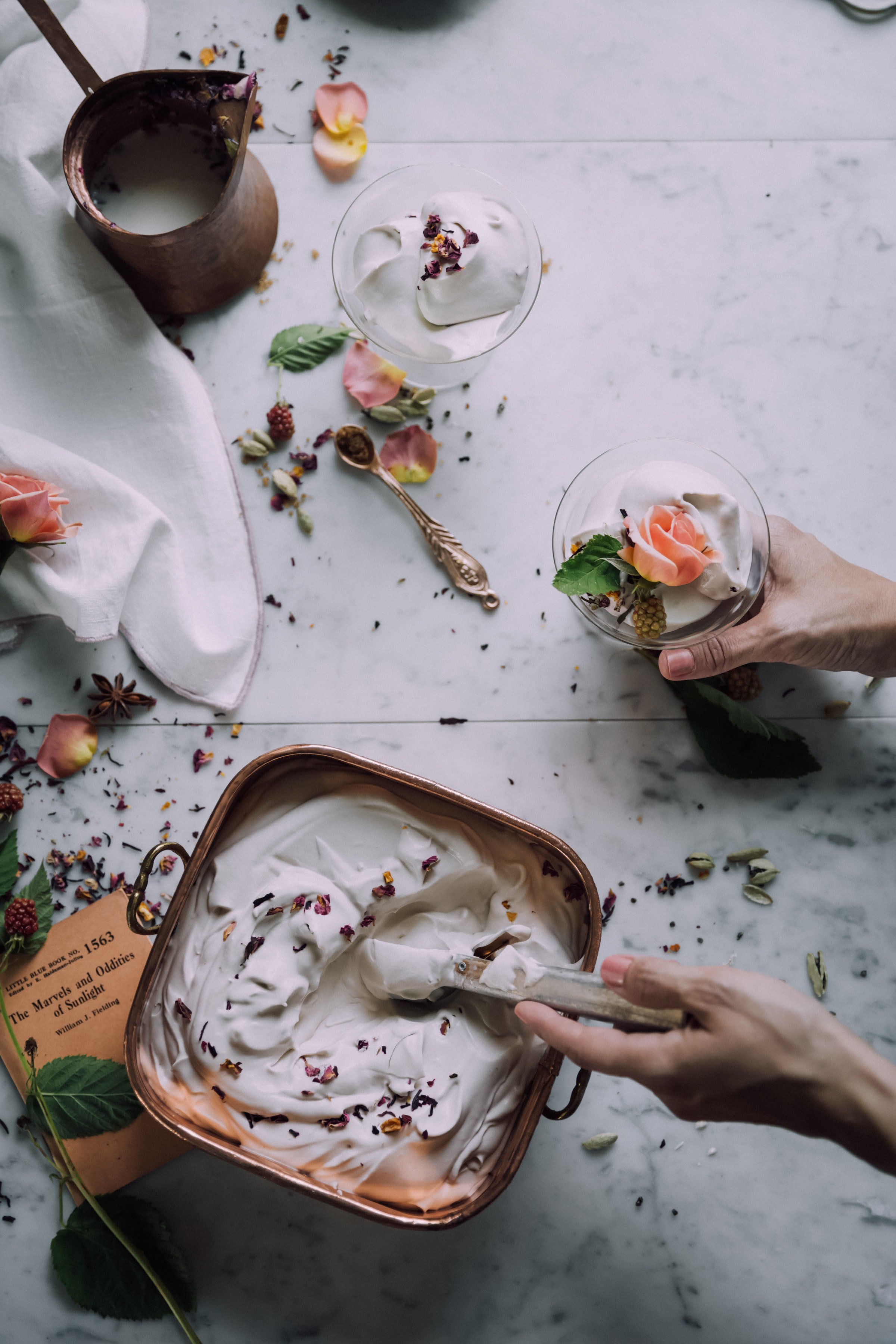 frozen yogurt in tray with hand scooping into bowls
