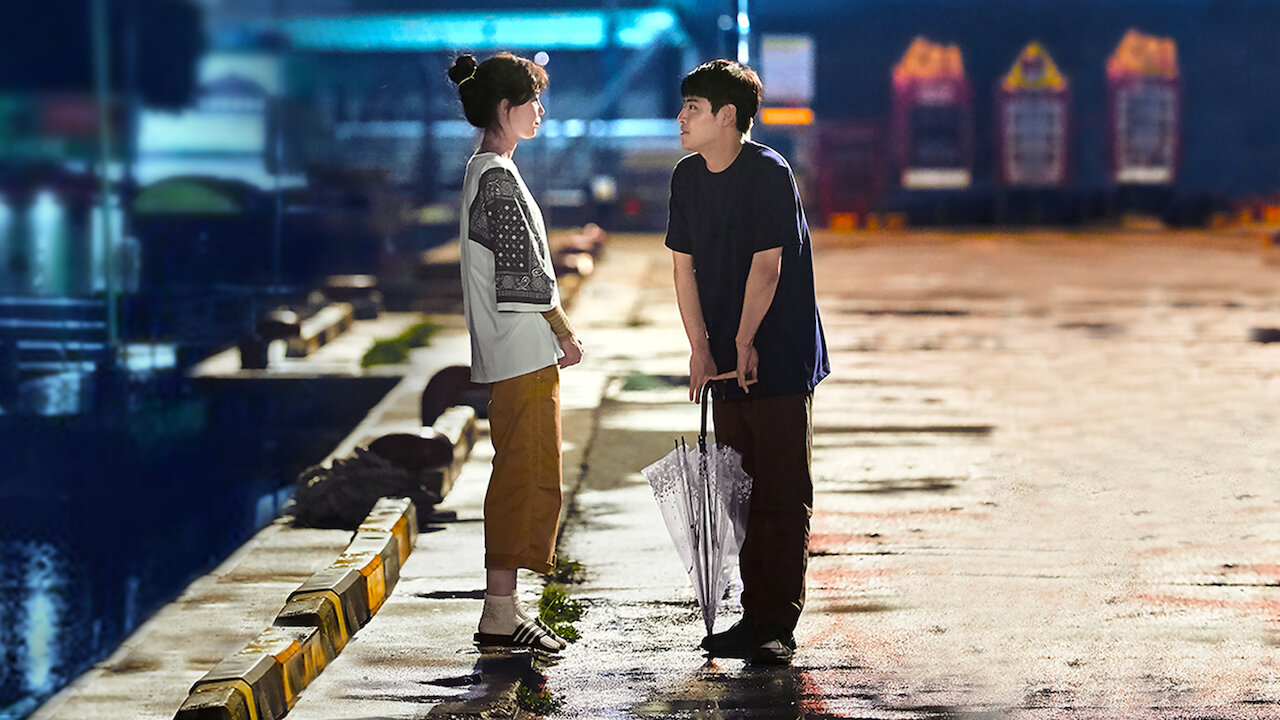 man and woman looking at one another late at night