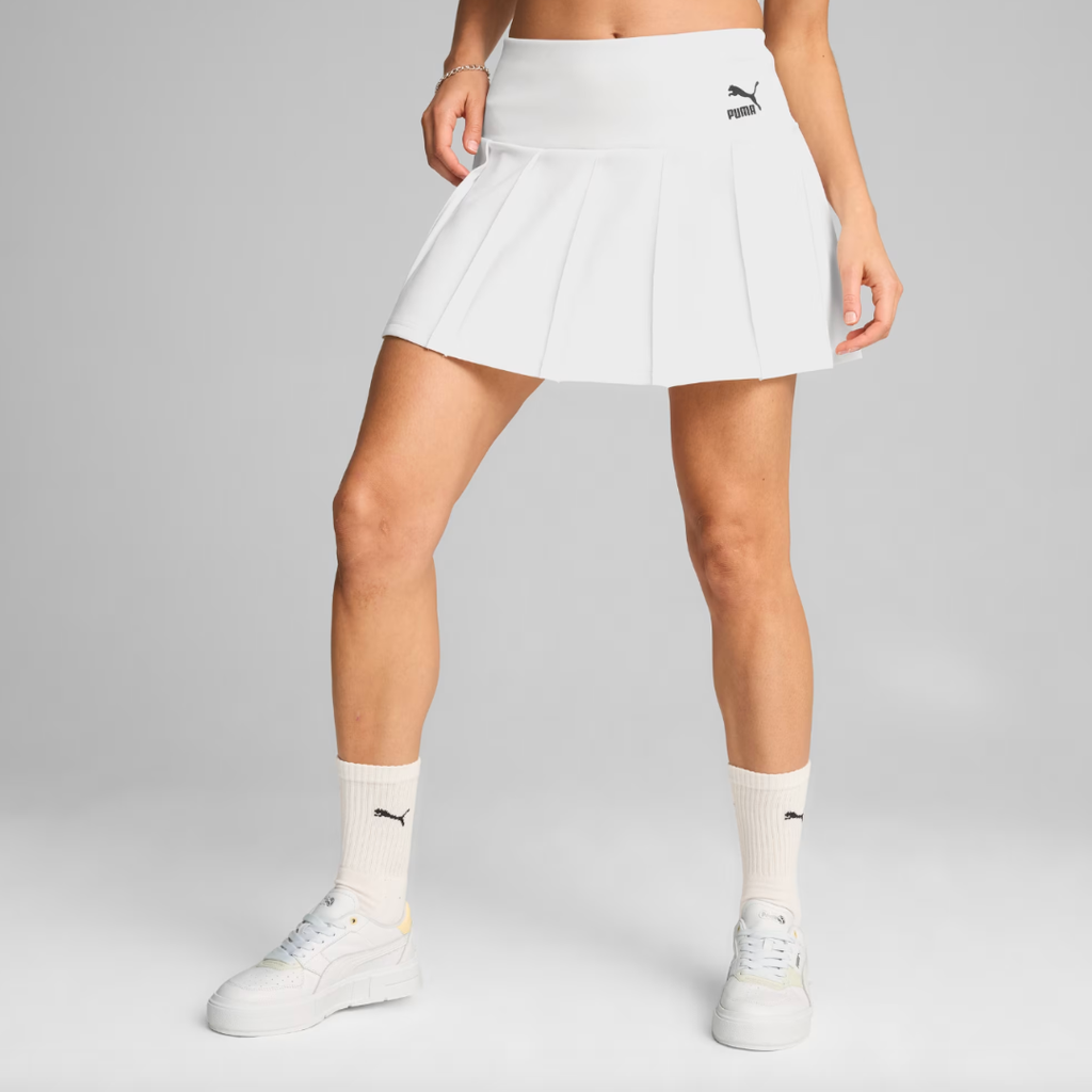 woman wearing a white tennis skirt and sneakers with ankle socks