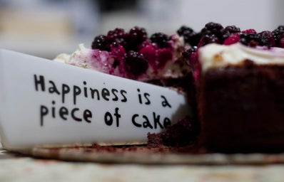 Blueberry pie with a quote beside the slice that says happiness is a piece of cake
