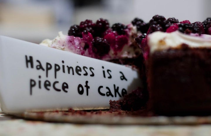 Blueberry pie with a quote beside the slice that says happiness is a piece of cake