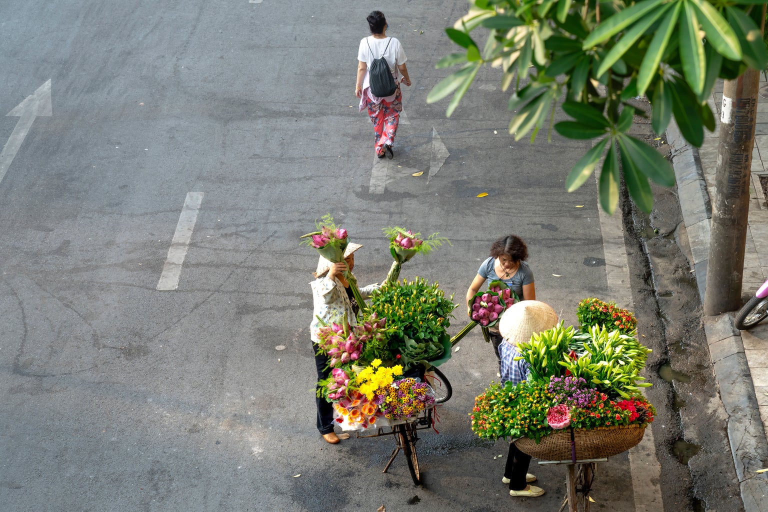 people selling and buying flowers in the street