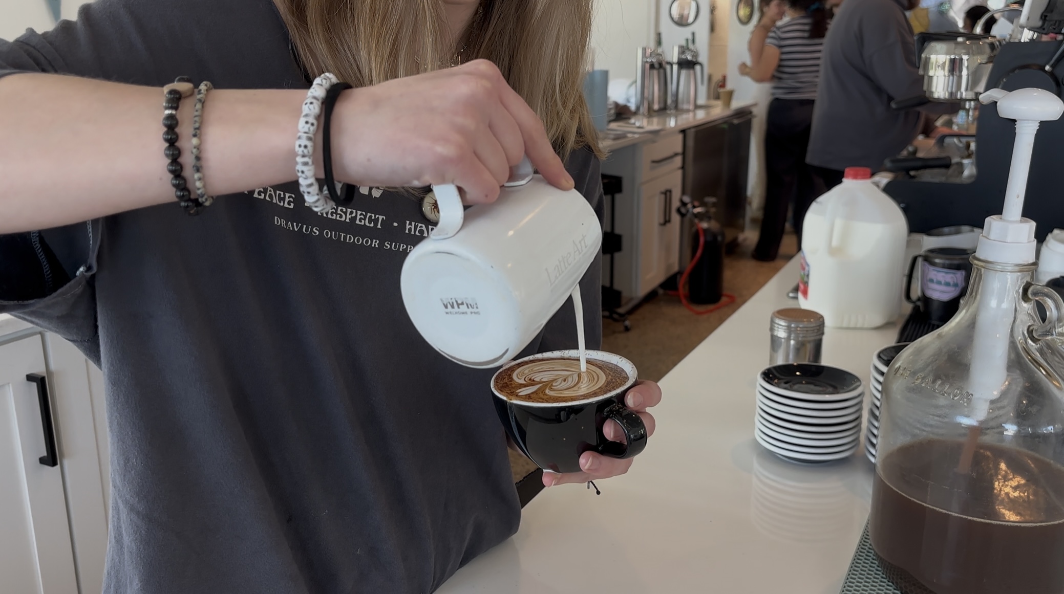photo of girl making latte art