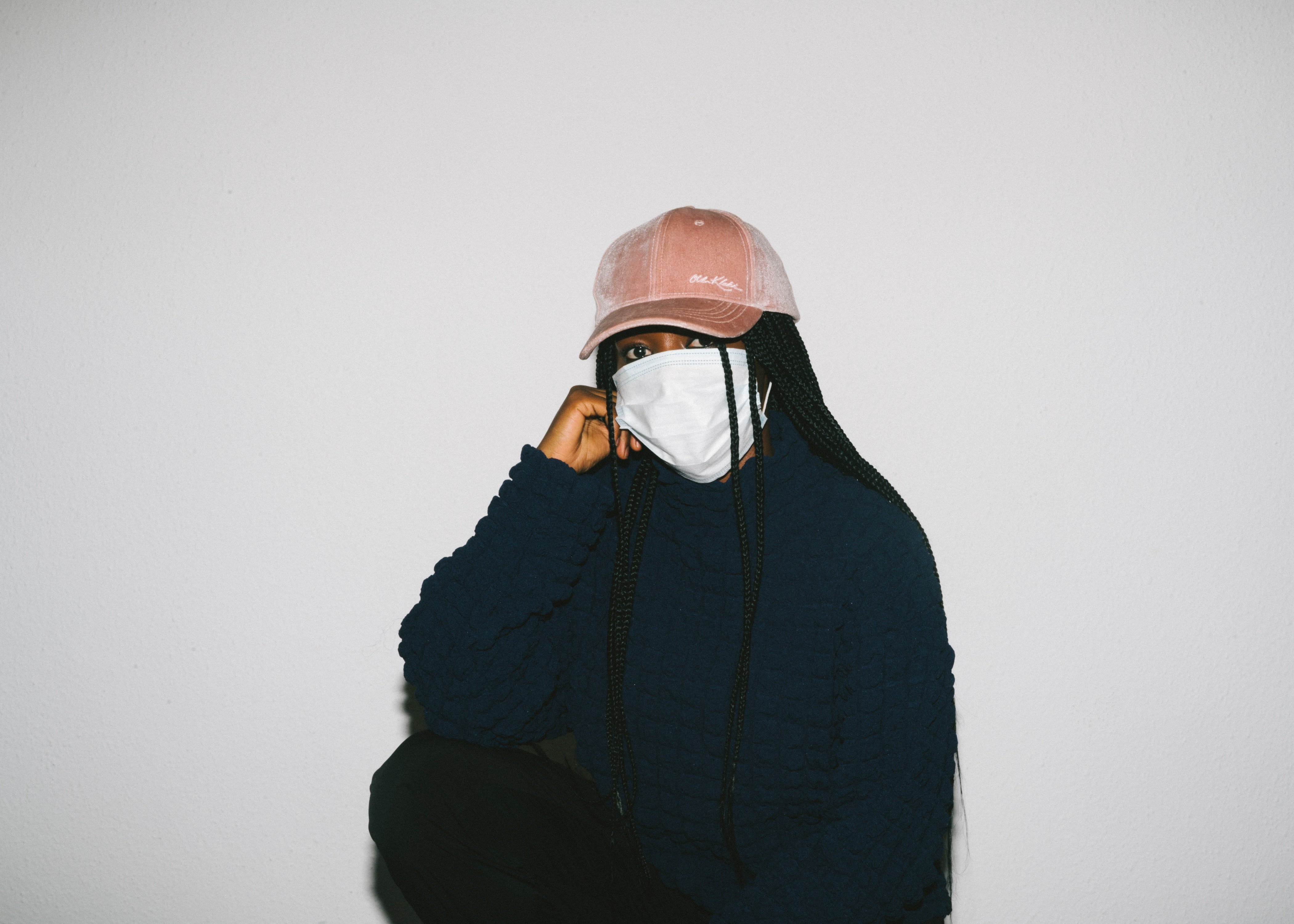 woman wearing medical mask and pink hat