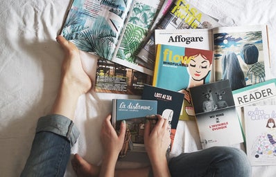 magazines spread out on a bed