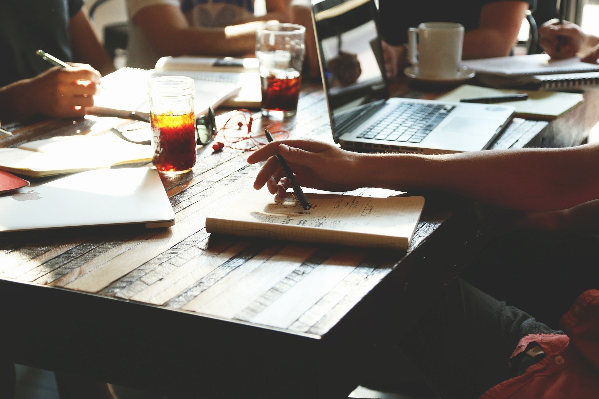 people at a coffee shop in meeting by StartupStockPhotos