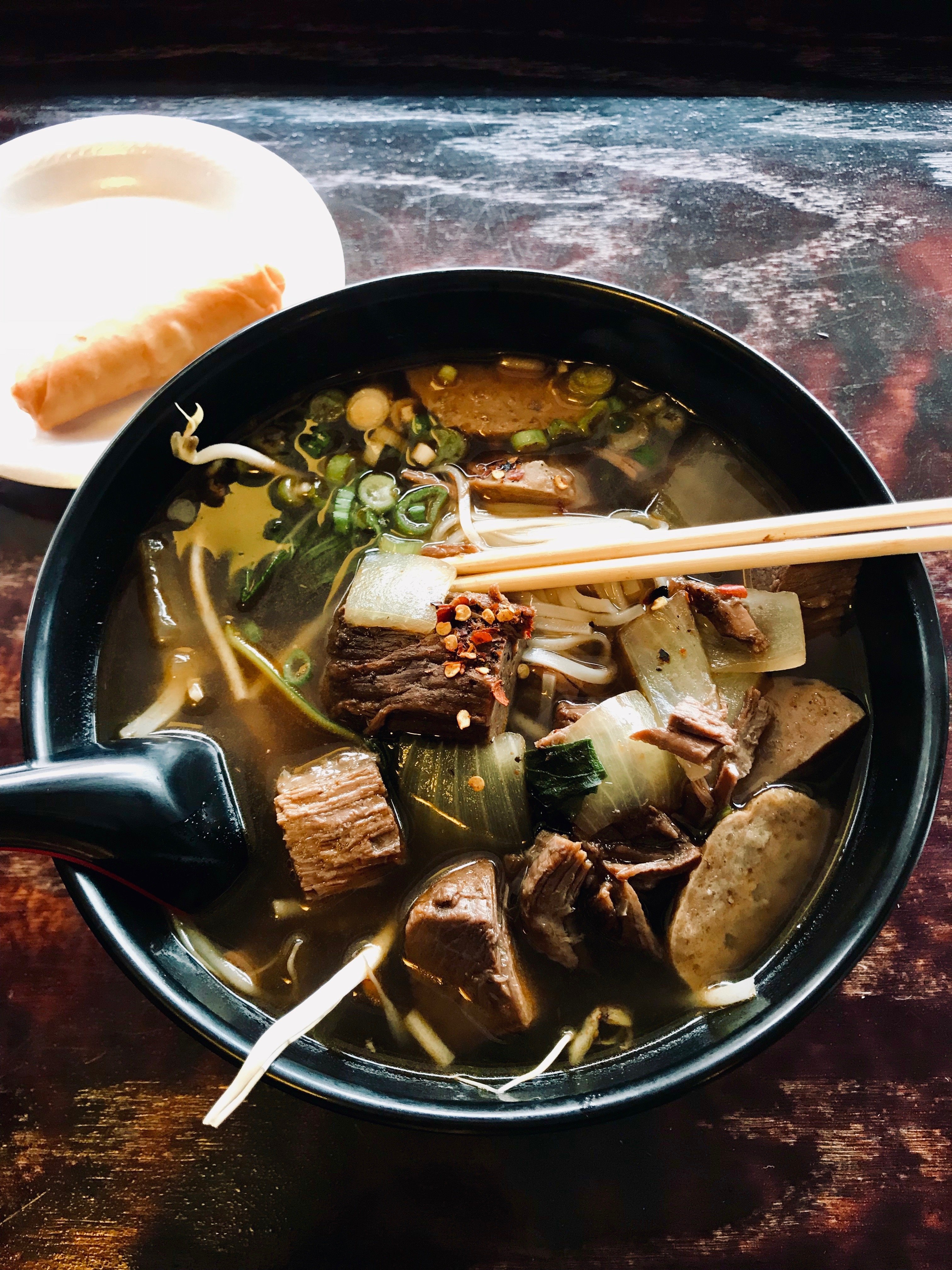 bowl of pho with chopsticks