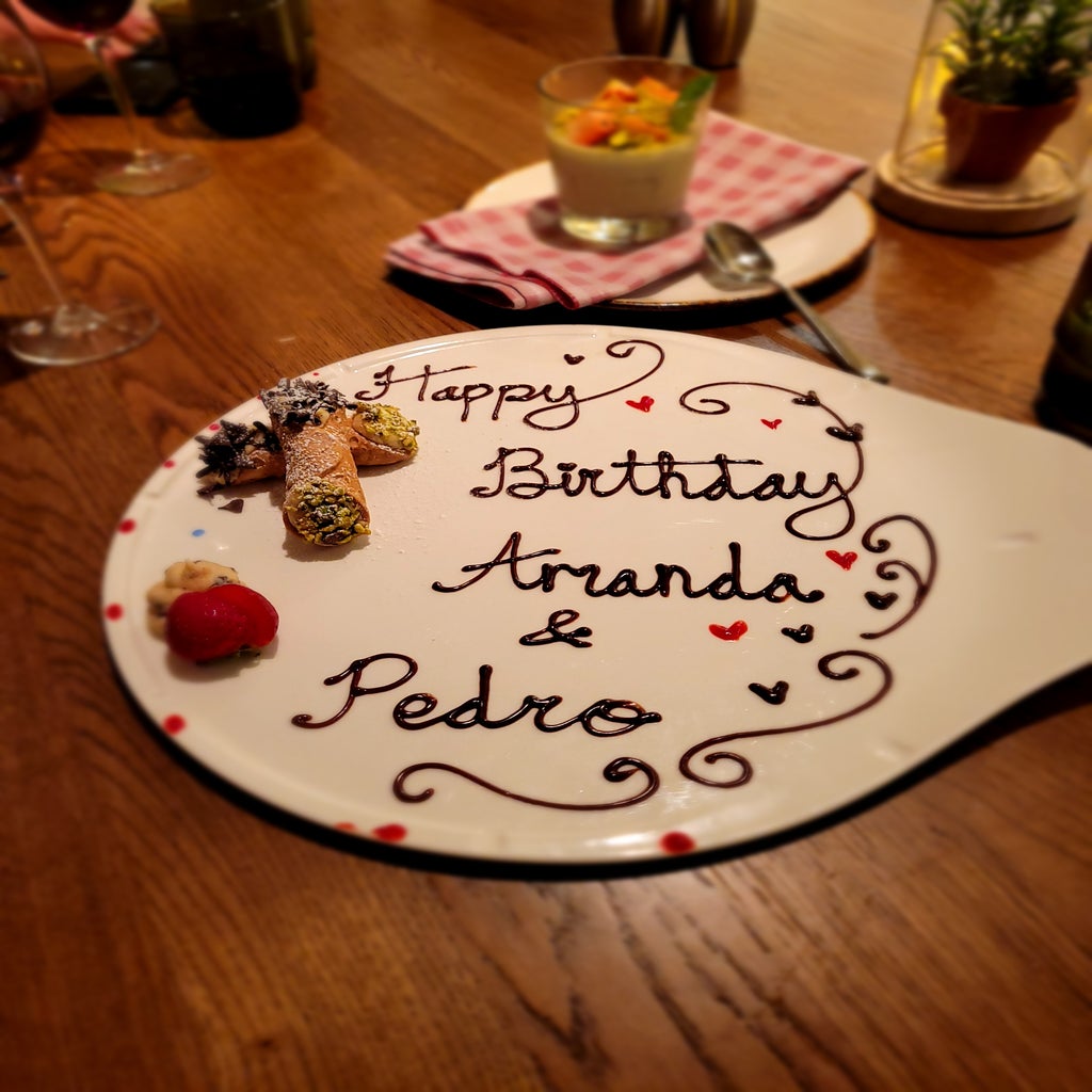 A dessert plate featuring handmade cannolis and chocolate text \