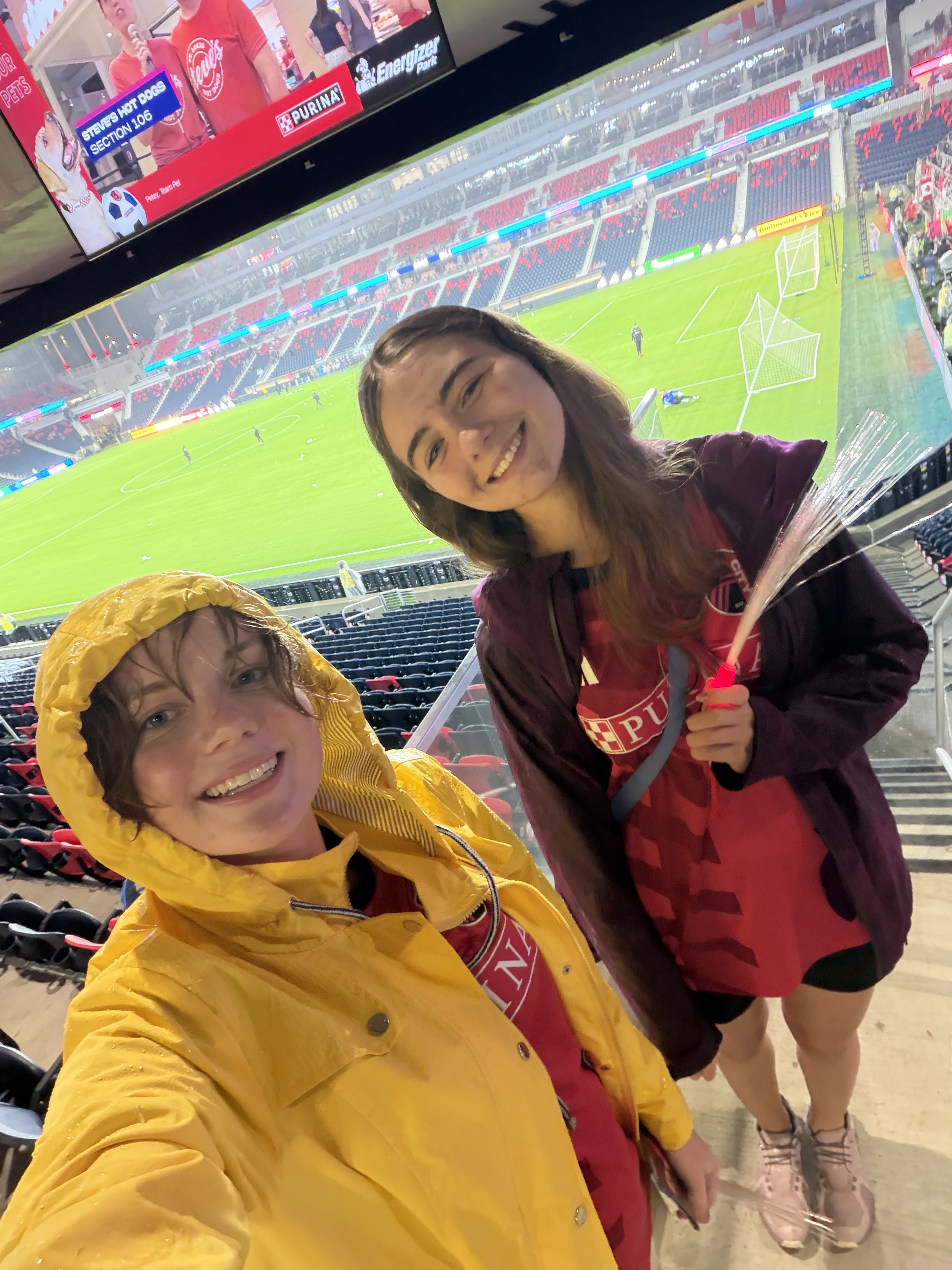 Two girls taking a selfie at a soccer game