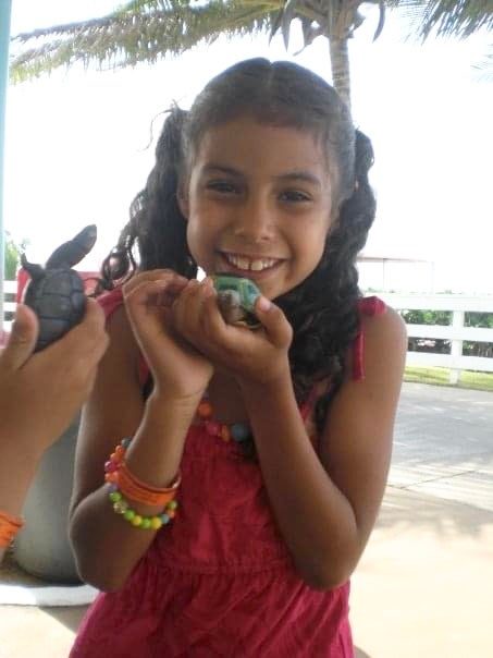 Childhood image of young girl smiling with toy