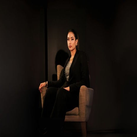Woman sitting on chair looking at camera