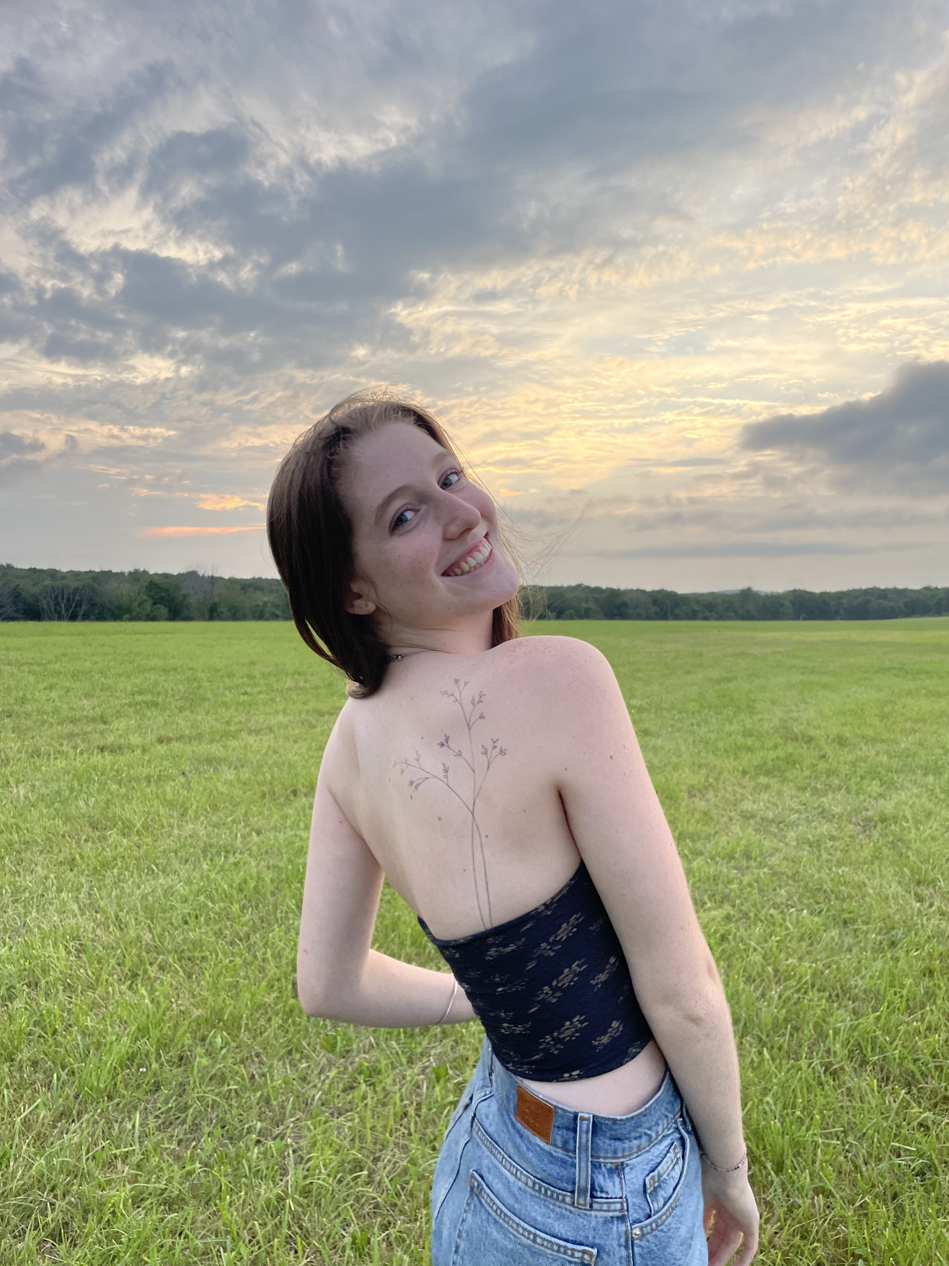 A photo of me where my back tattoo is visible. I would love to use for my article about my experience with getting tattoos!