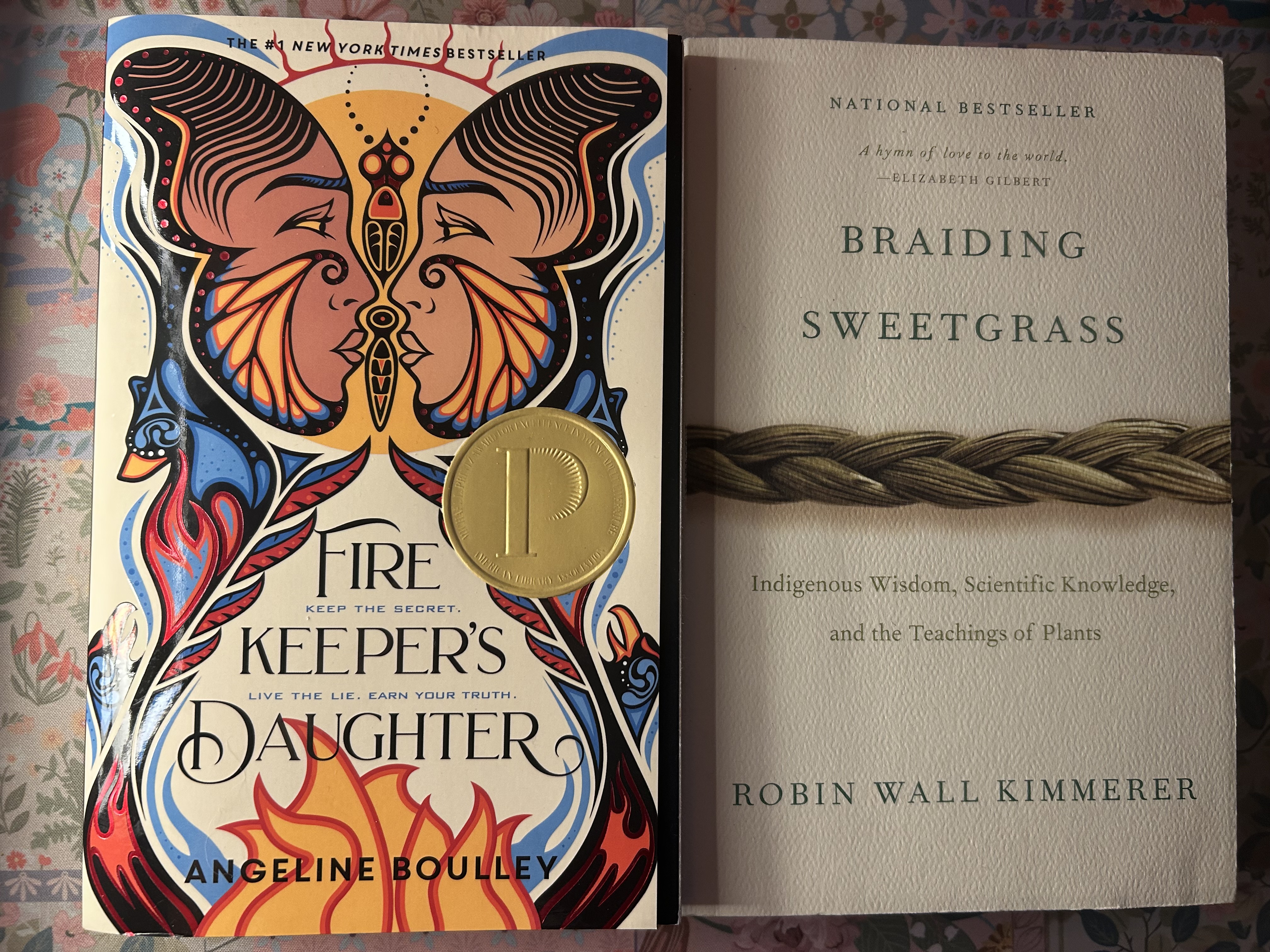 Two books lying next to each other, Fire Keeper\'s daughter by Angeline Boulley and Braiding Sweetgrass by Robin Wall Kimmerer