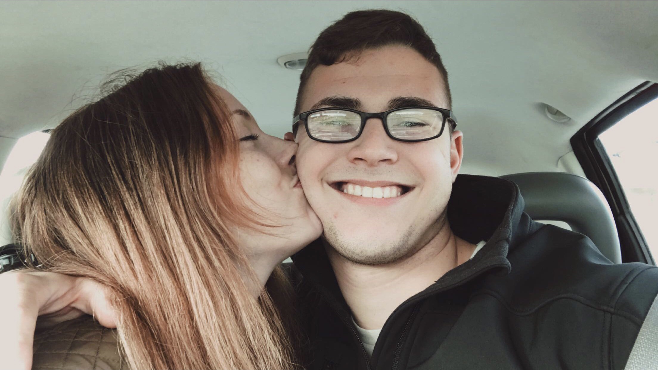 woman kissing man on the cheek