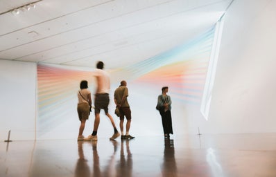 people walking in museum blurred