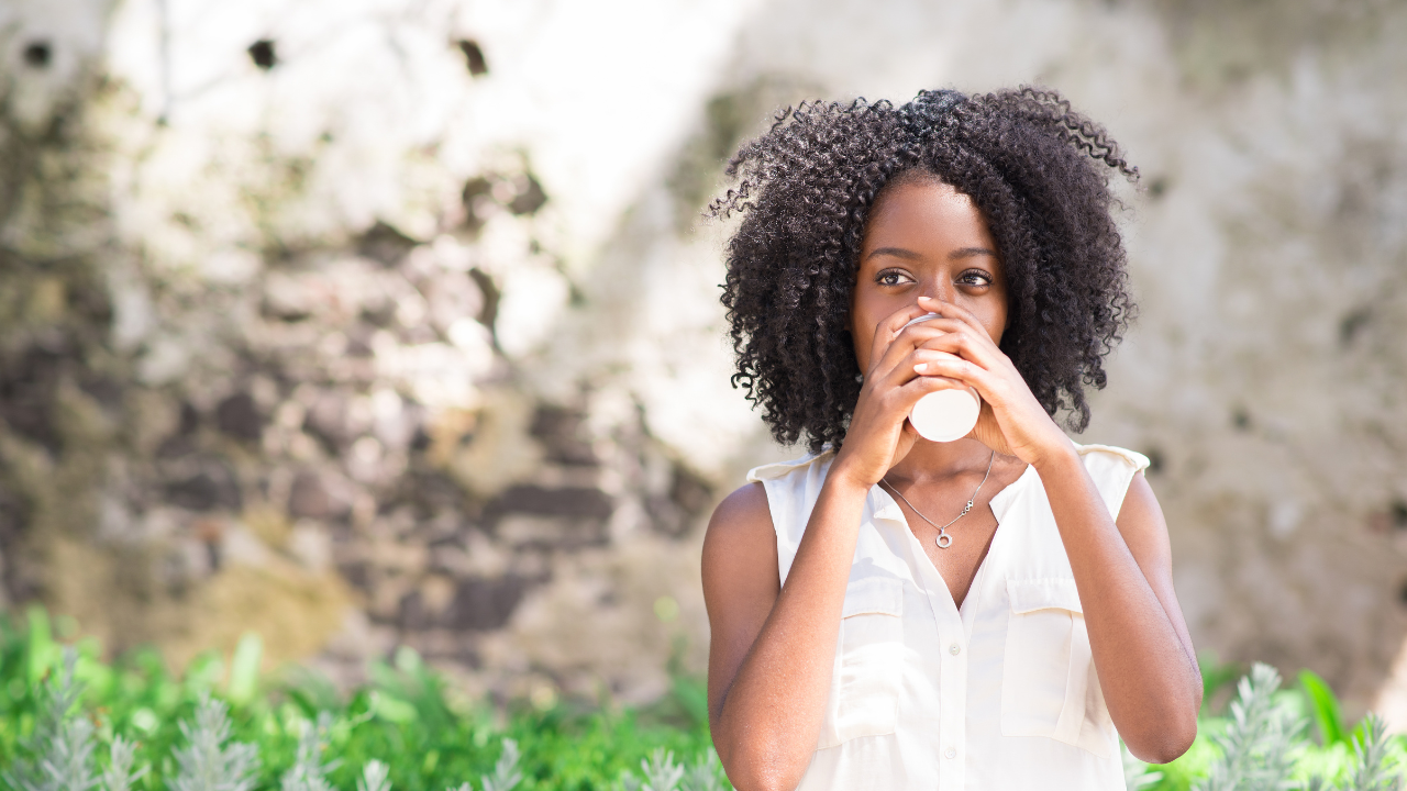 Woman outside with coffee cup