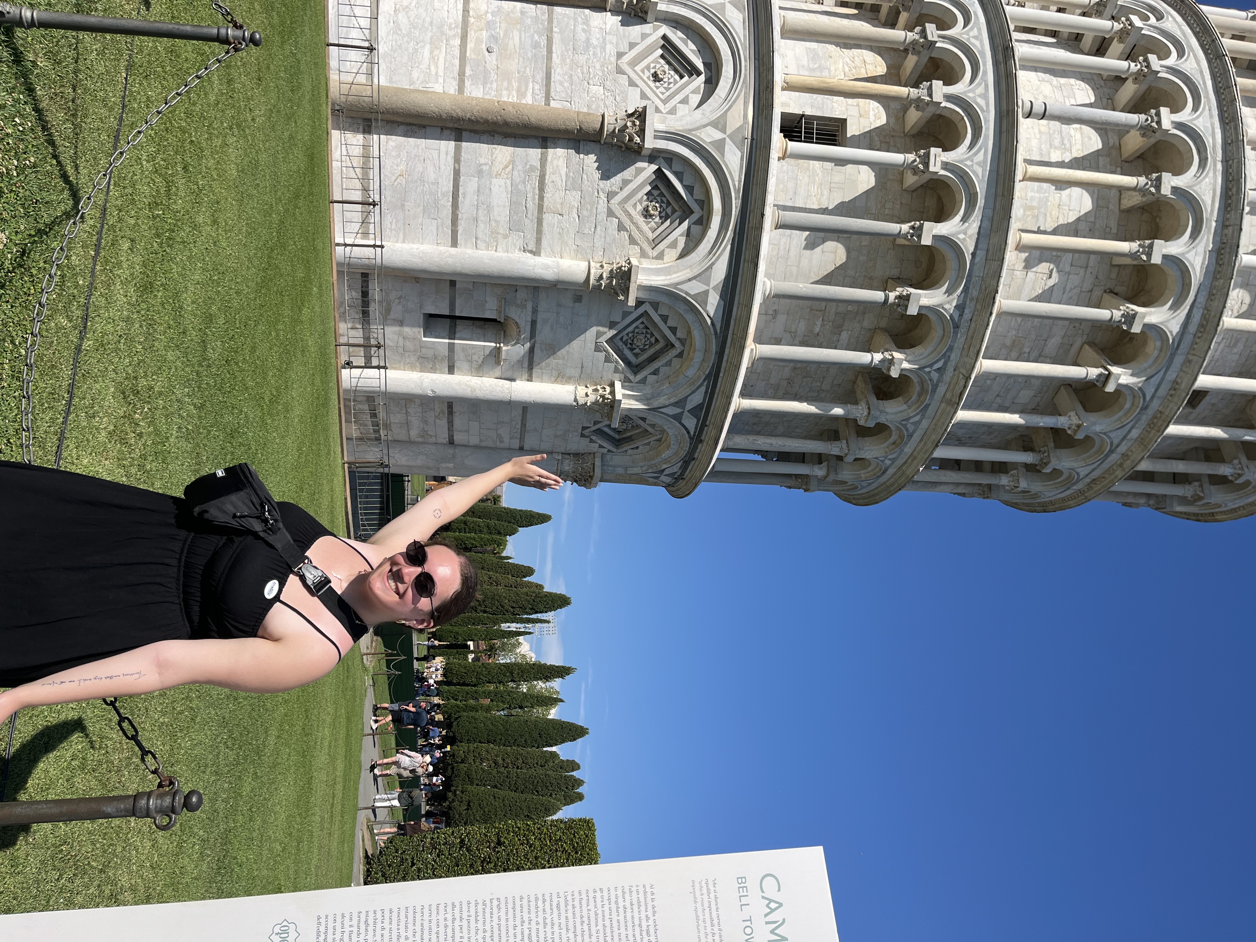 author posing at the Leaning Tower of Pisa in Pisa, Italy