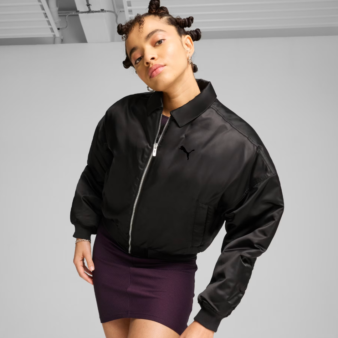 woman wearing a black satin bomber jacket and purple mini skirt