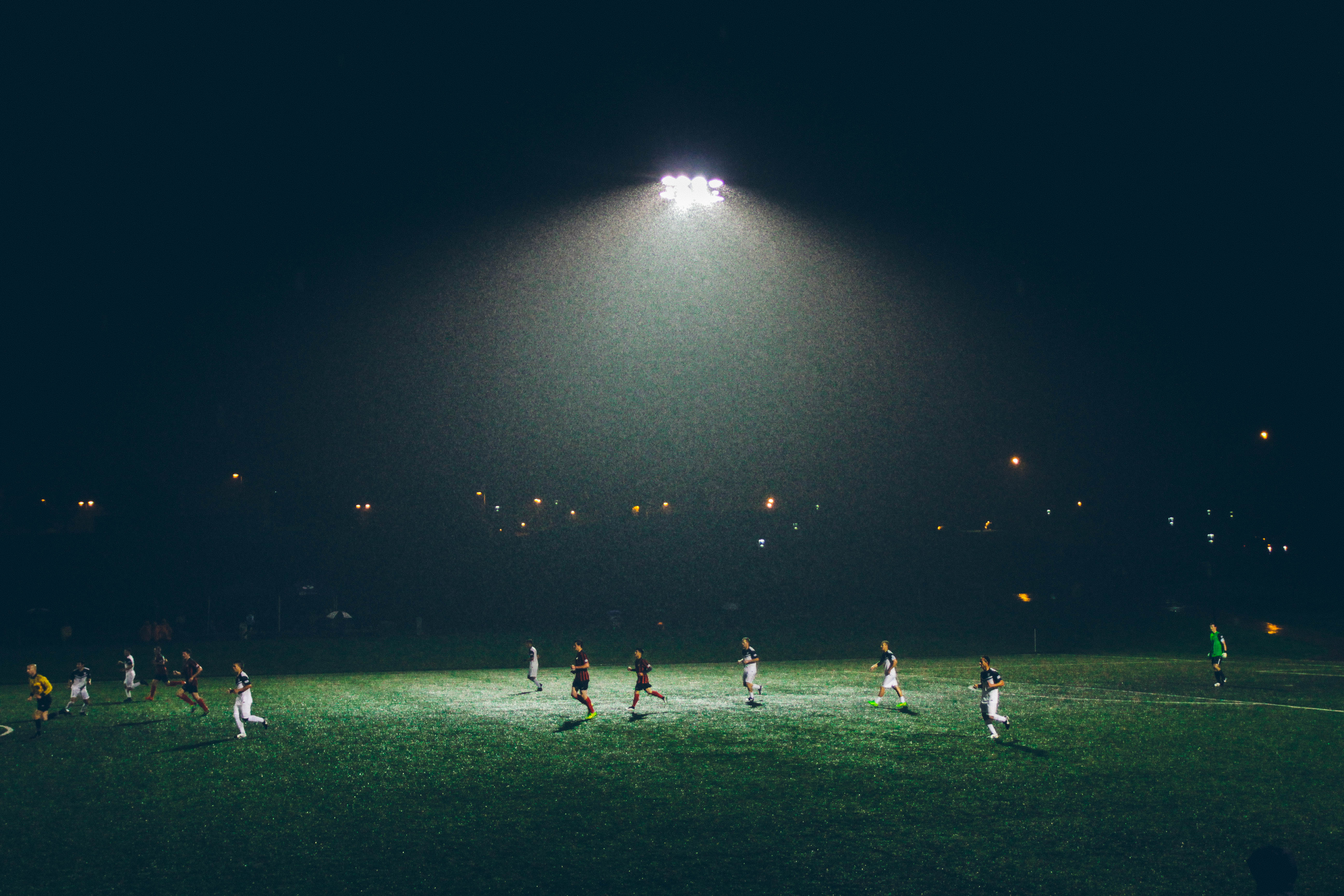 Dark soccer field with players