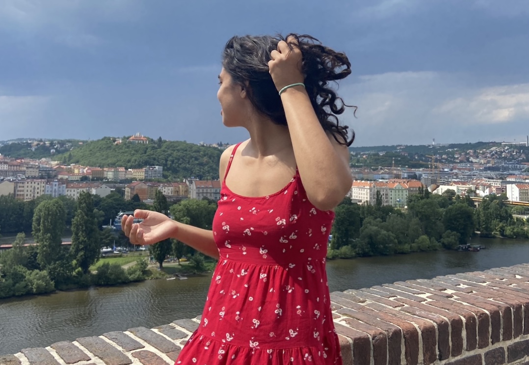 Girl standing on a bridge in Prague.