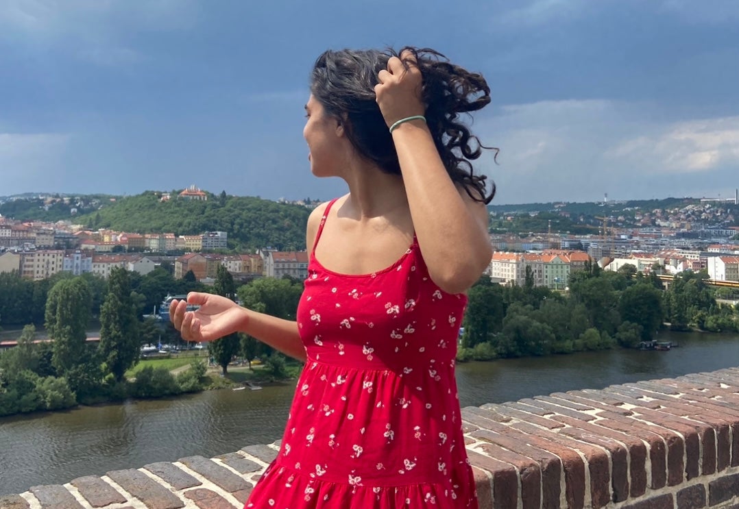 Girl standing on a bridge in Prague.