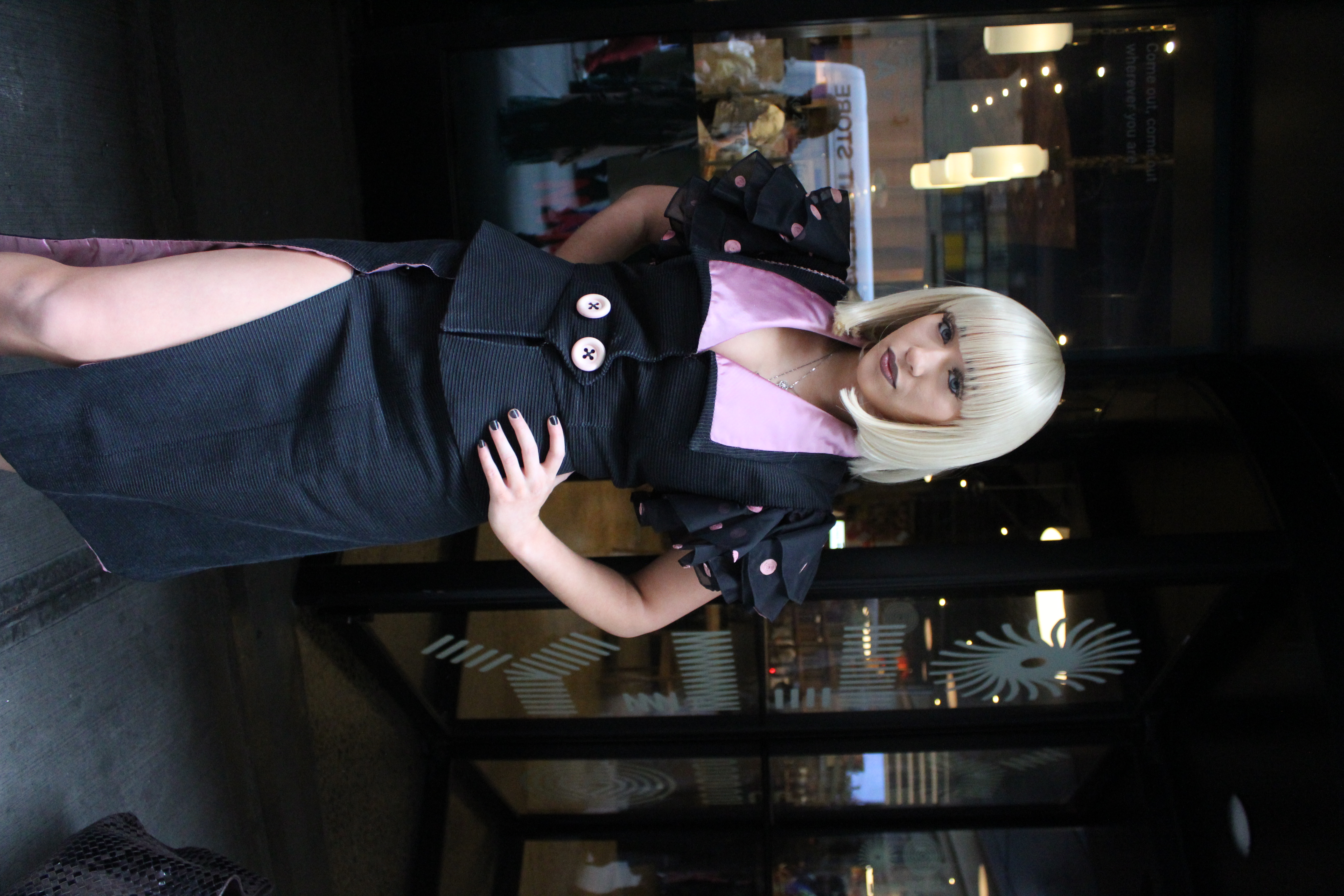 Woman in black and pink poses at NYFW