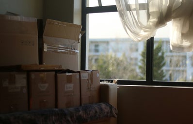 a room with boxes and a window