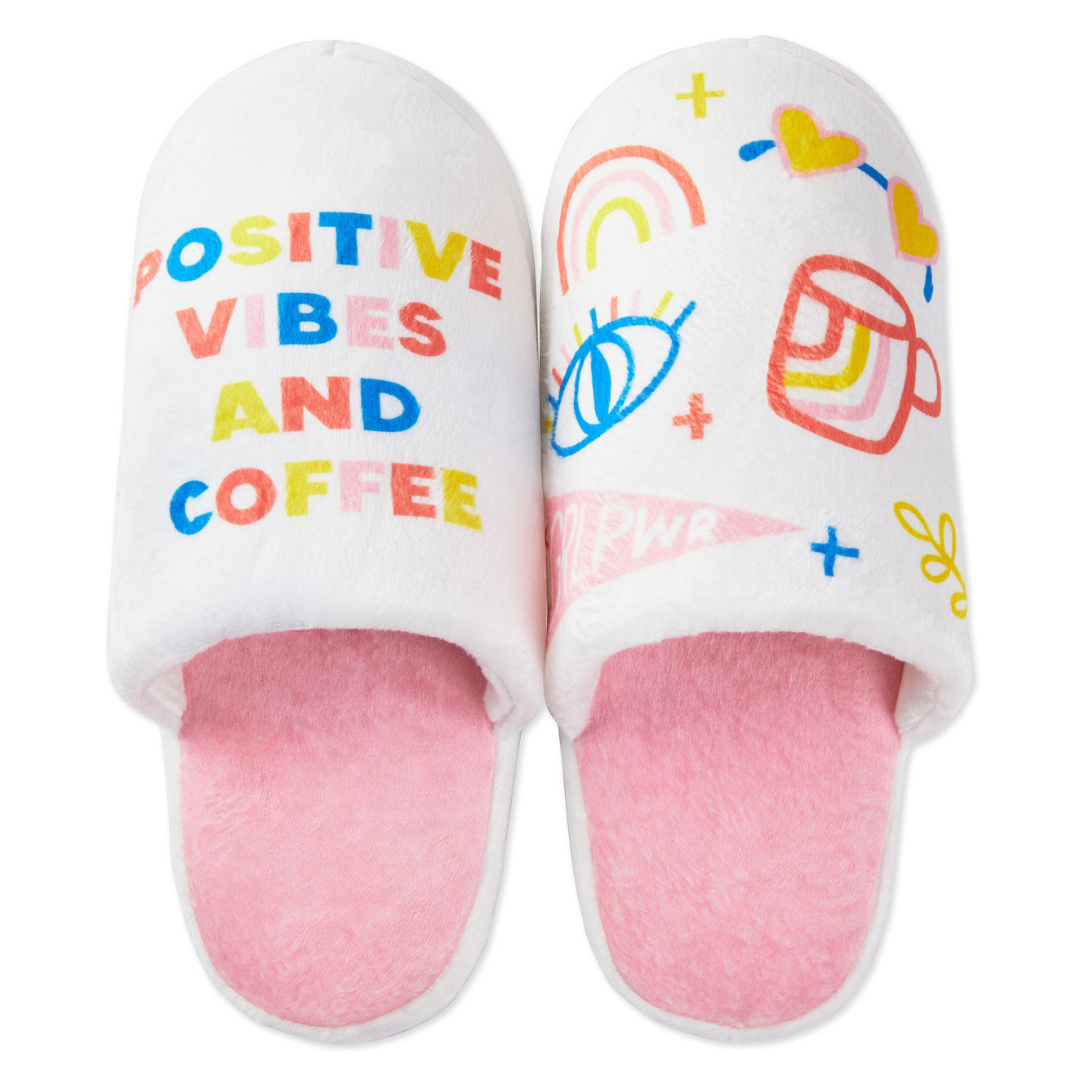 white and pink slippers with printed illustration and text that reads \