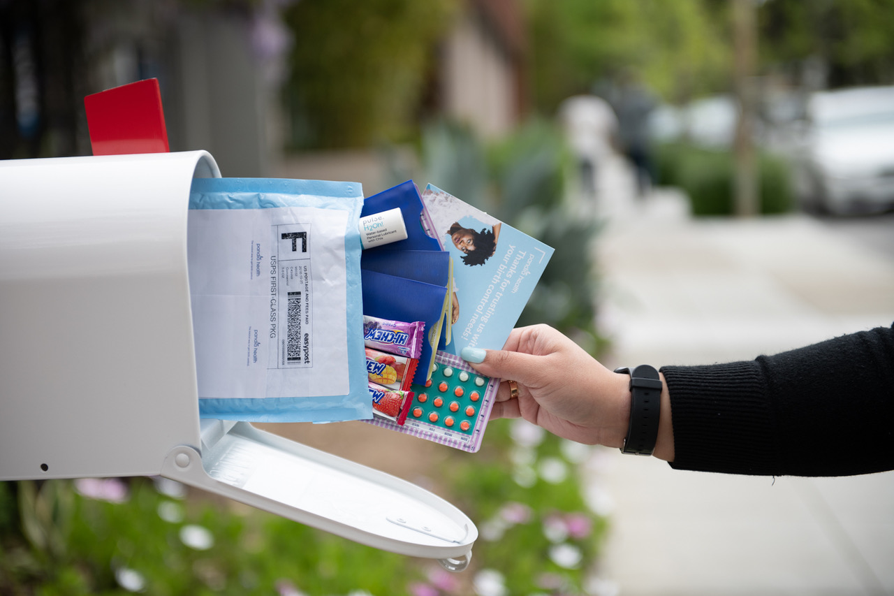 A mailbox with medicine, flyers, and candy coming out