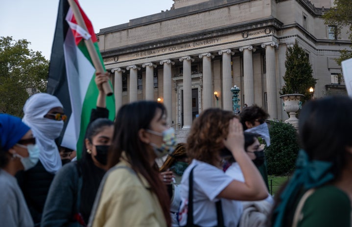 college students at columbia university with palestinian flag