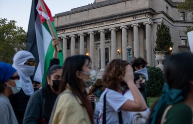 college students at columbia university with palestinian flag