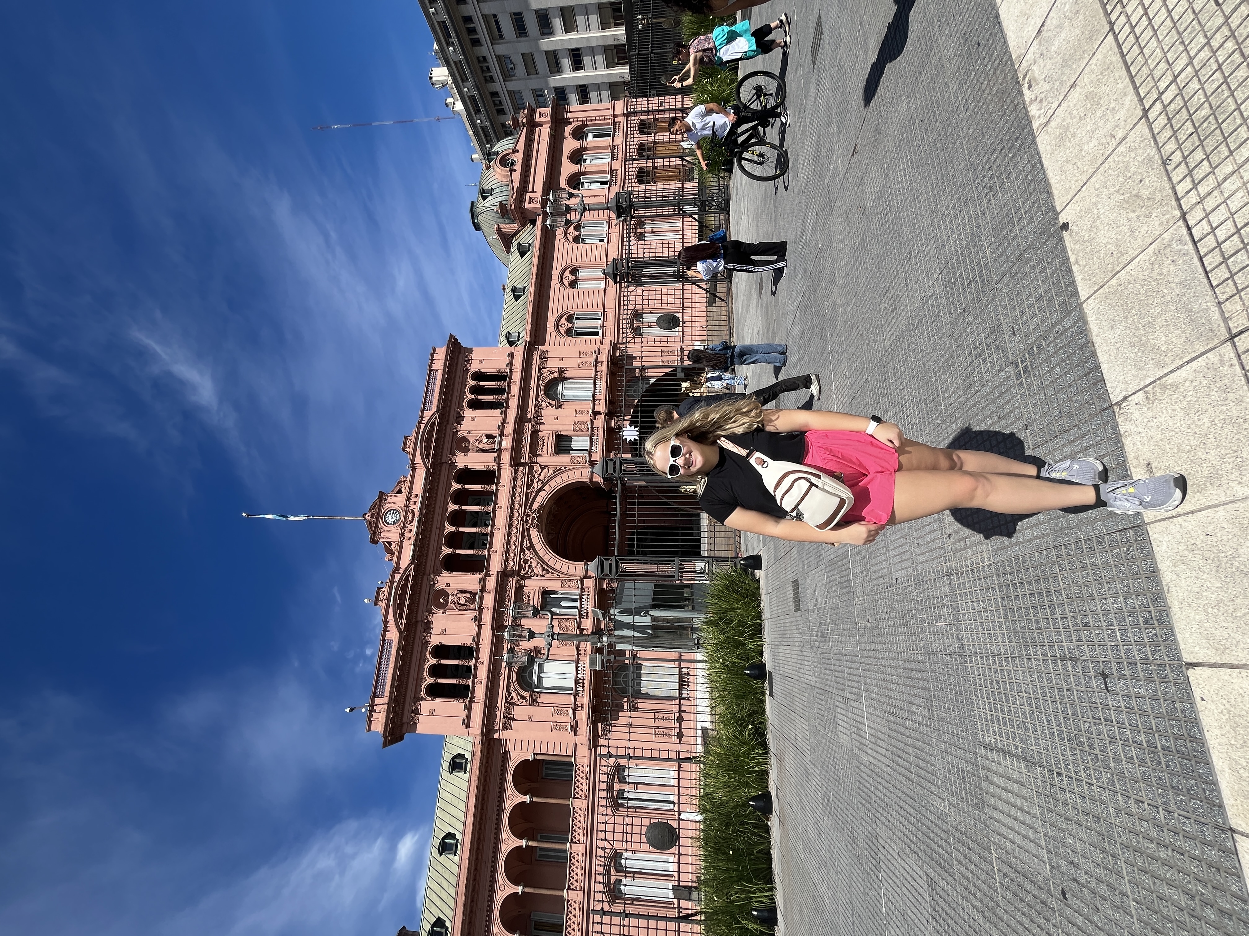 Girl stands in front of Casa Rosado