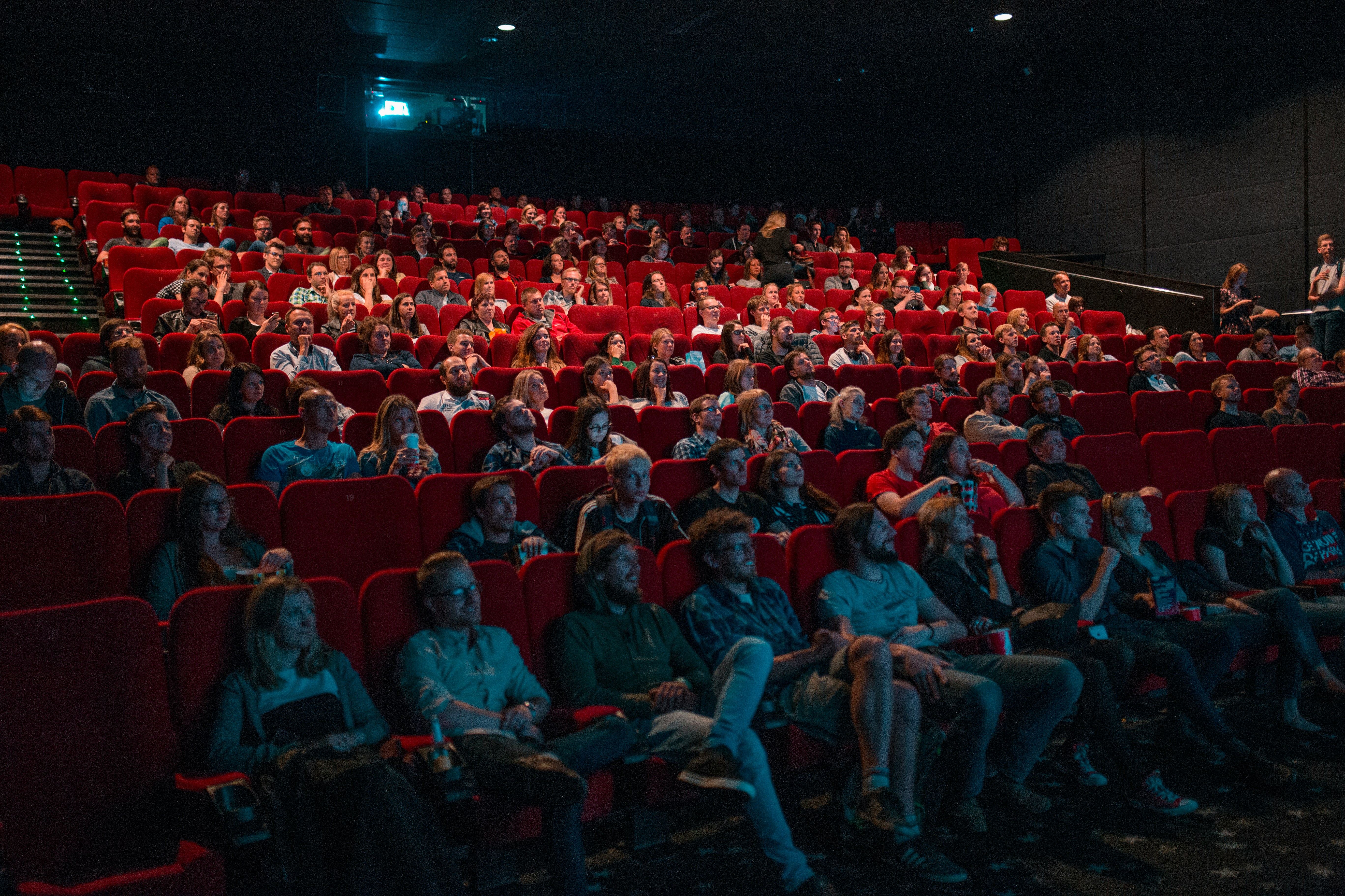 crowd of people watching a movie in a theater.
