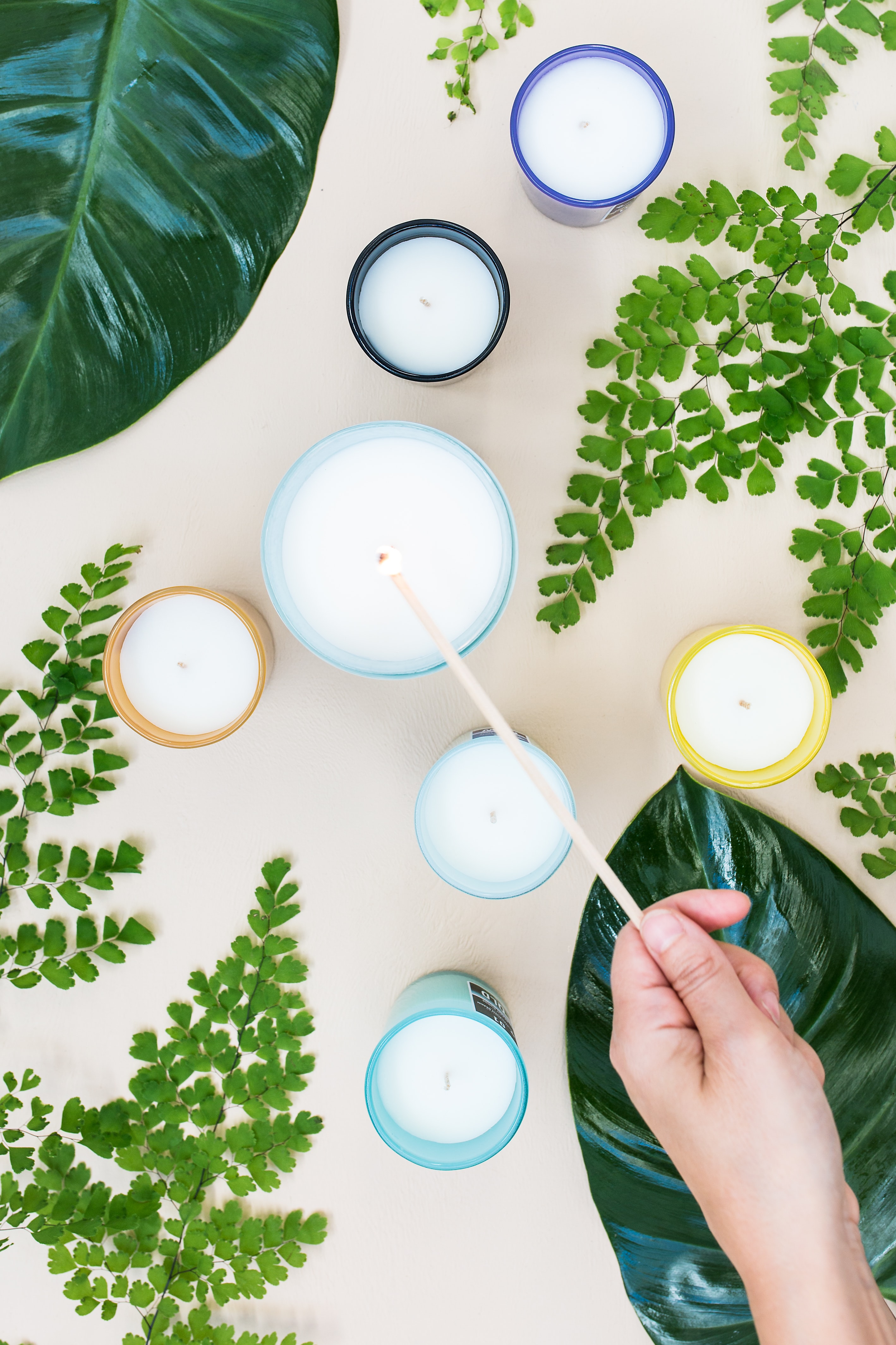 lighting candles surrounded by greenery by Noelle Australia on Unsplash