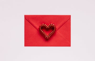 Red envelope with heart on pink background