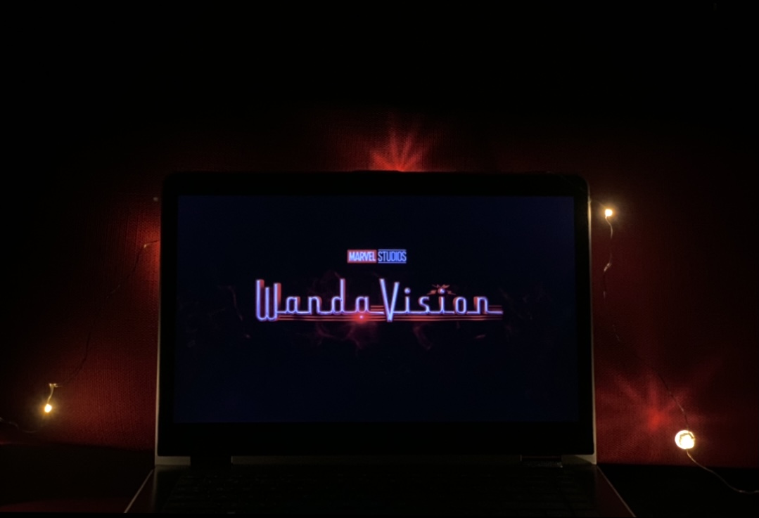WandaVision show on laptop with twinkling lights