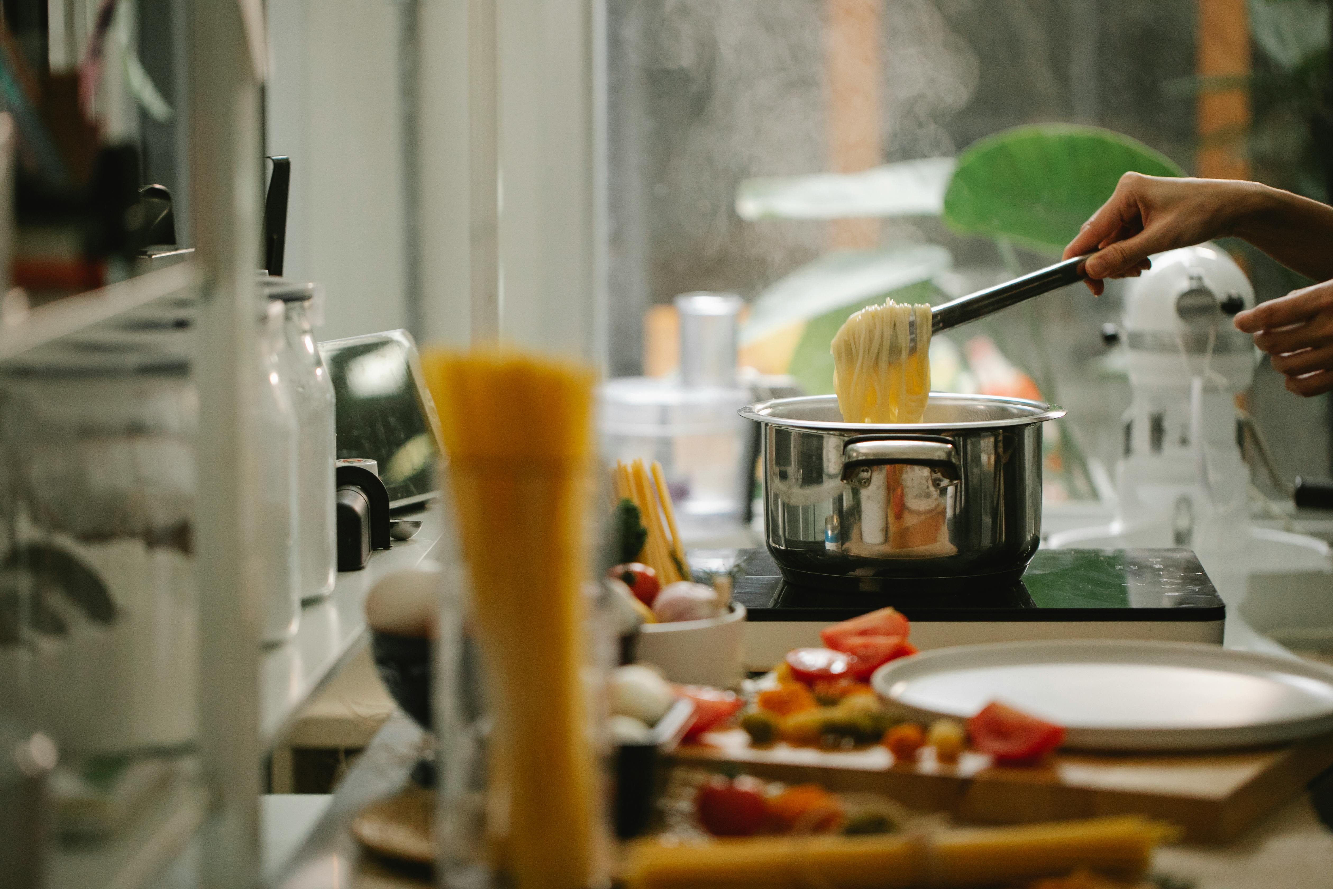 Kitchen where someone is cooking pasta on stovetop.