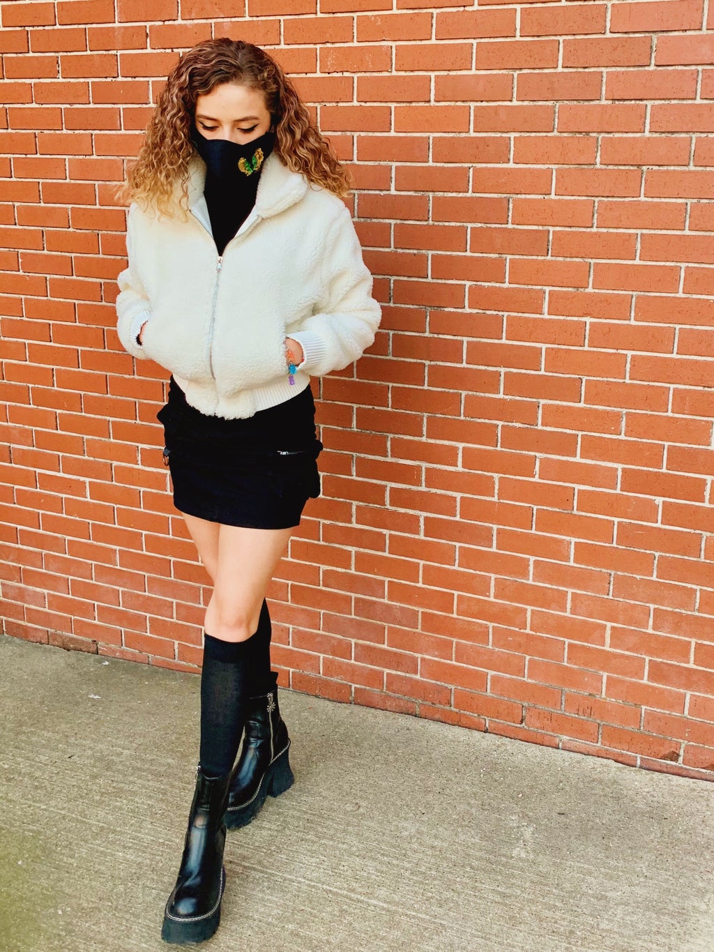 Girl in black outfit and white fur coat.