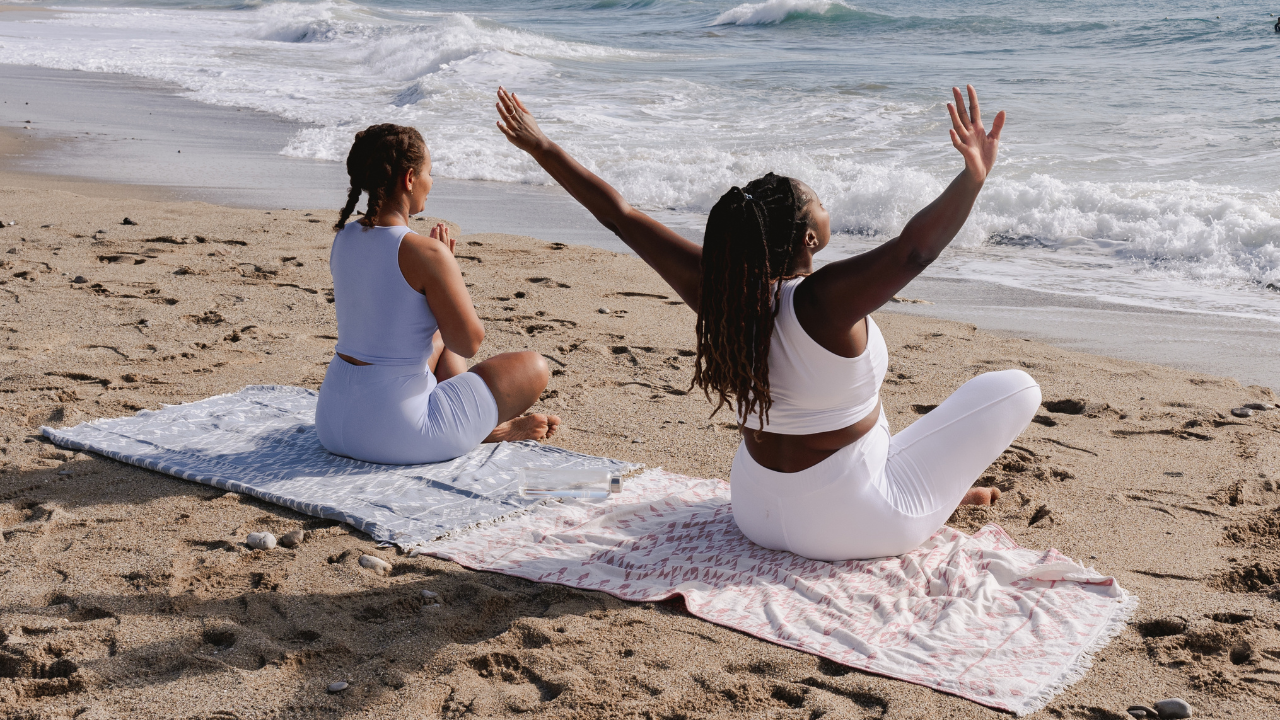Girls doing yoga at the beach