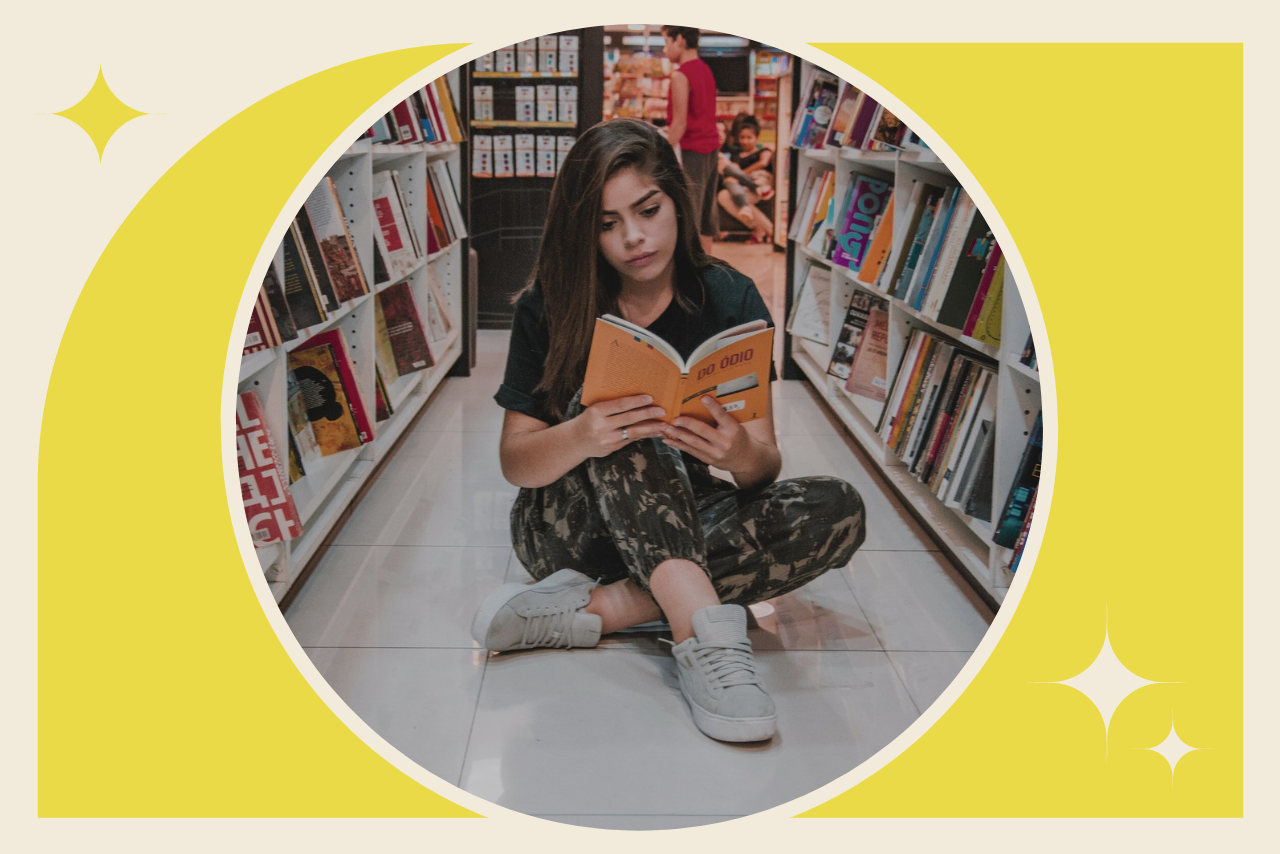 woman reading on the floor of a bookstore