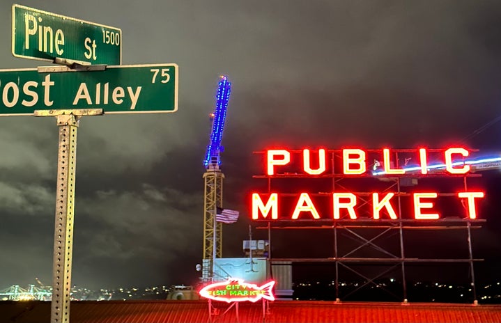 A street sign and neon sign at Pike Place Market in Seattle, Washington.