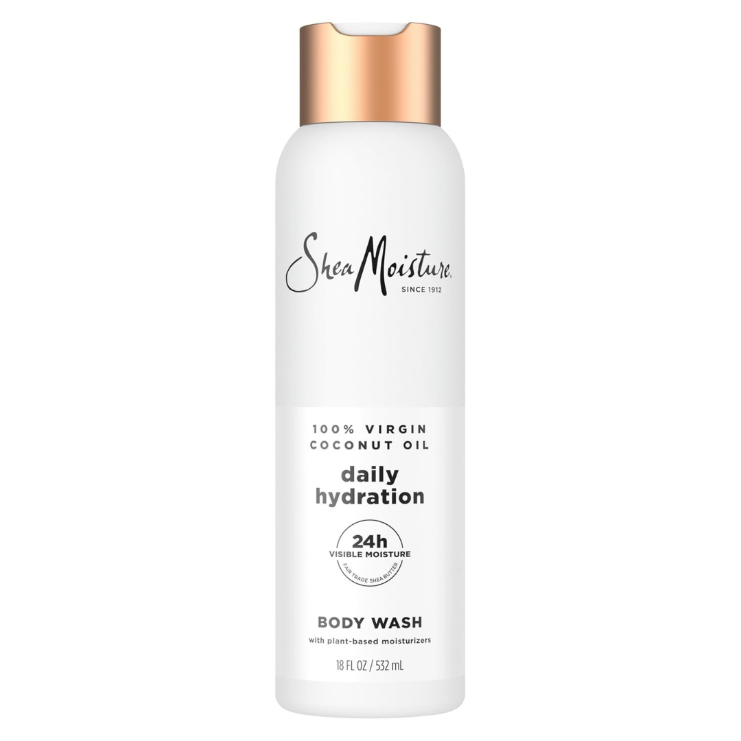 A bottle of SheaMoisture Daily Hydration Body Wash with 100% Virgin Coconut Oil. The label highlights 24-hour visible moisture with plant-based moisturizers. The bottle is 18 fl oz (532 mL) with a copper-colored cap.